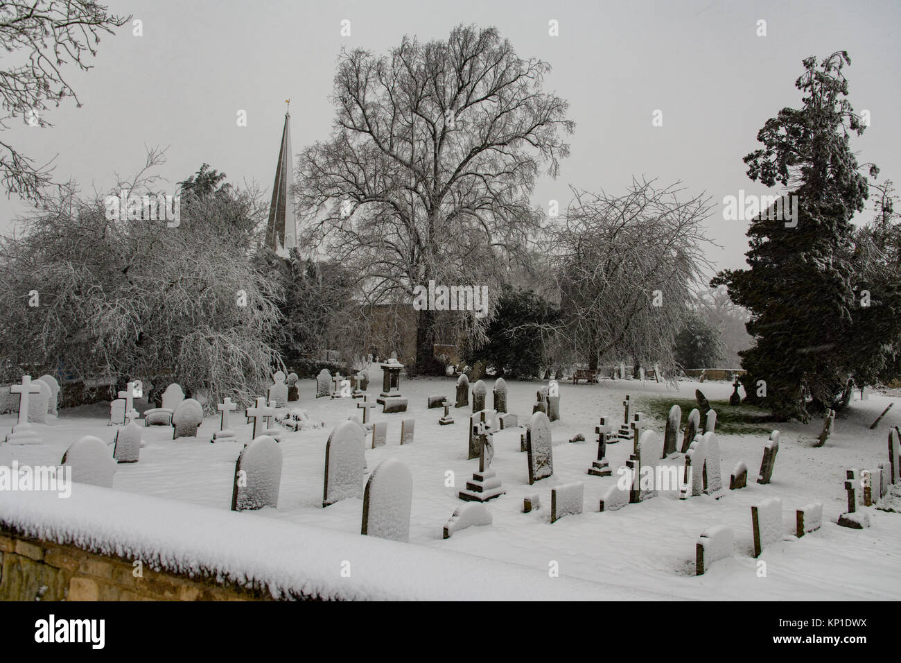 A Cotswold graveyard fin Winter Stock Photo
