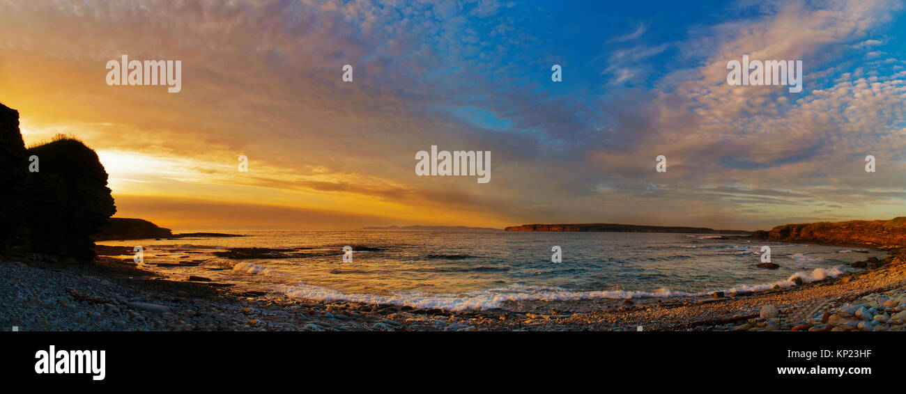 Panoramic view of a summer sunset over the Pentland Firth, Caithness, northern Scotland, looking across to Orkney. Stock Photo