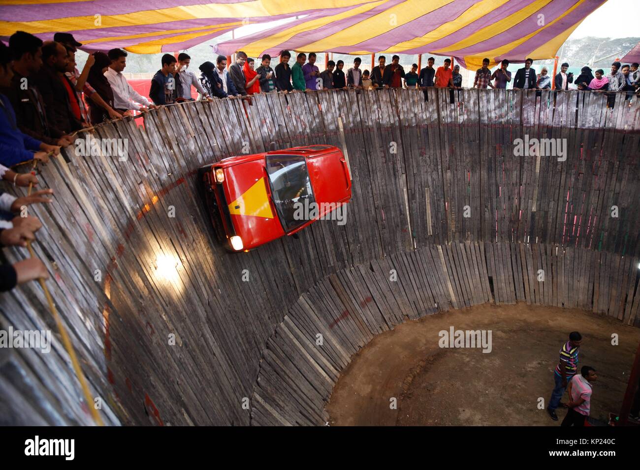 Dhaka, Bangladesh. A Bangladeshi man drive four wheeler inside a hole. It is a Circus as Death Hole Car driving. Stock Photo