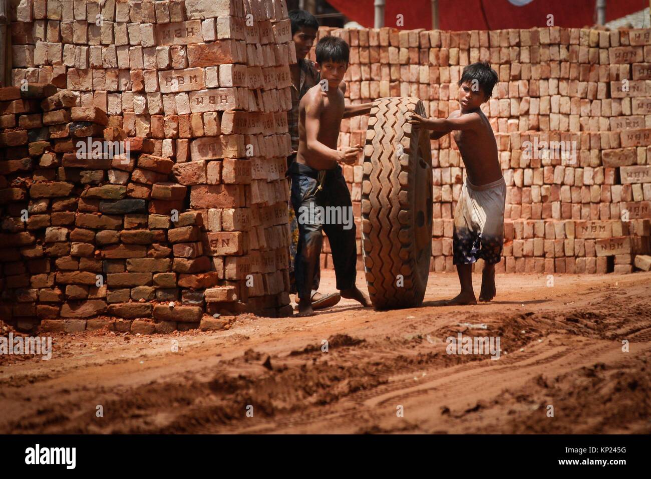 Bangladeshi Child labor break bricks at Postogola brick breaking yard in Dhaka, Bangladesh, on June 3, 2017. With over half of the population living Stock Photo