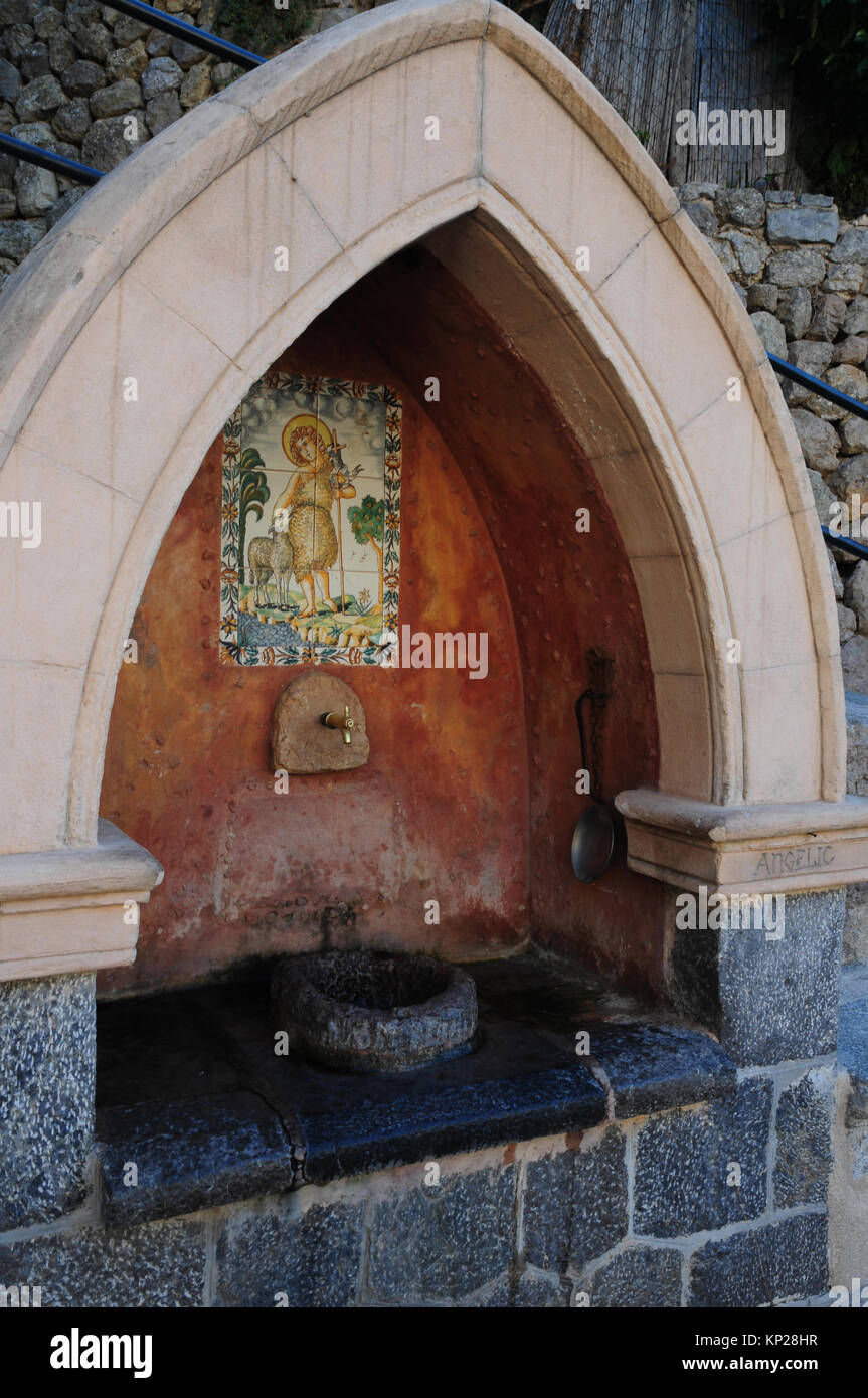 Public water fountain in the village of Deia, Mallorca, Spain. Stock Photo