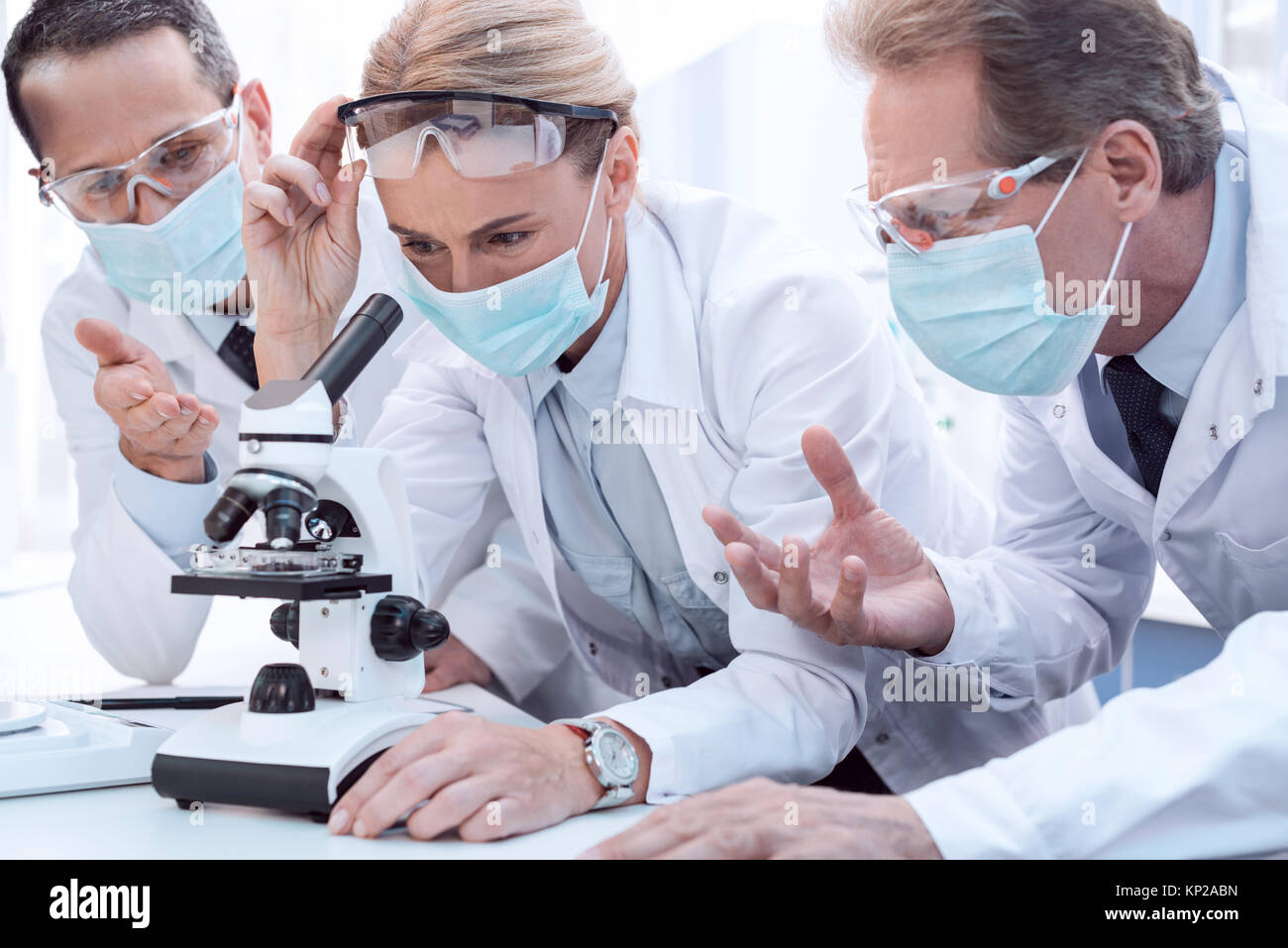Doctors using microscope Stock Photo Alamy