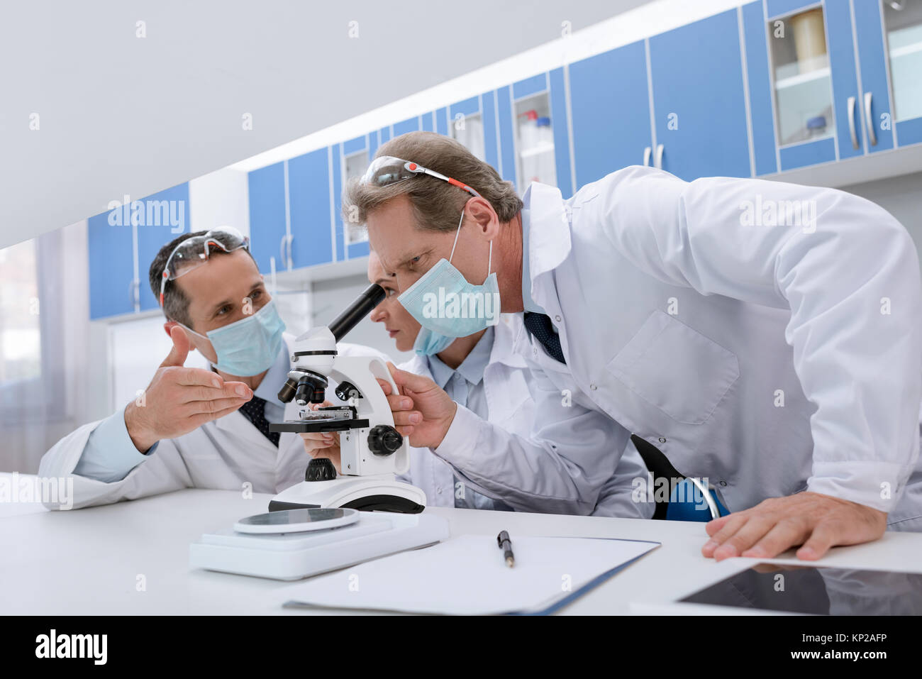 Scientists working with microscope Stock Photo Alamy
