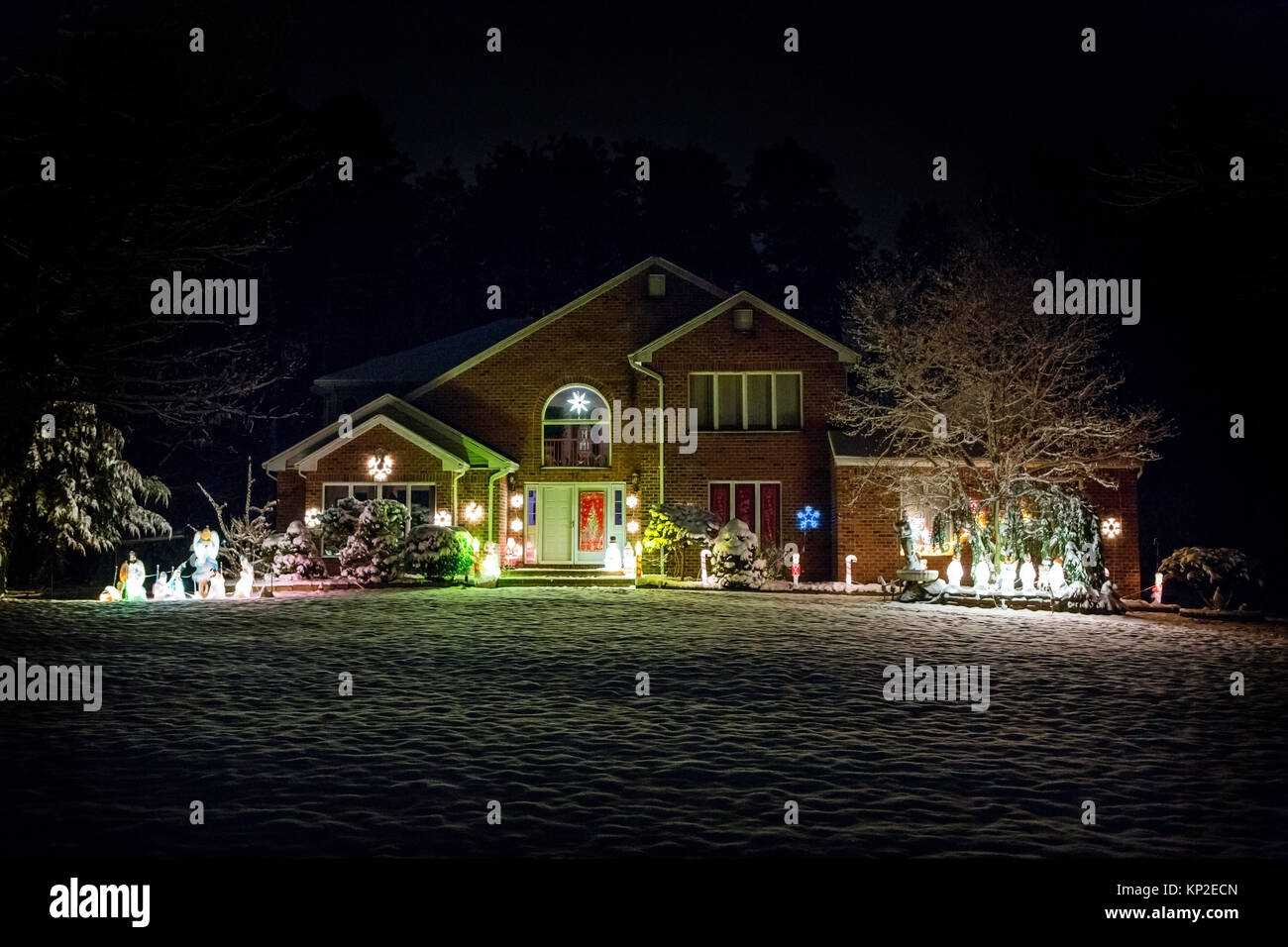 Decorated house for Christmas at night covered in snow Stock Photo - Alamy