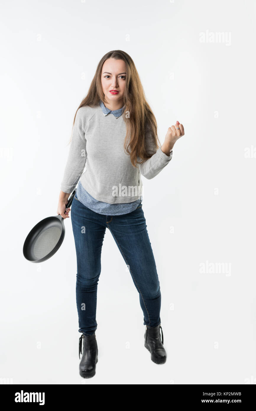 pretty woman with rage, umbragem, insult on her face and frying pan Stock Photo