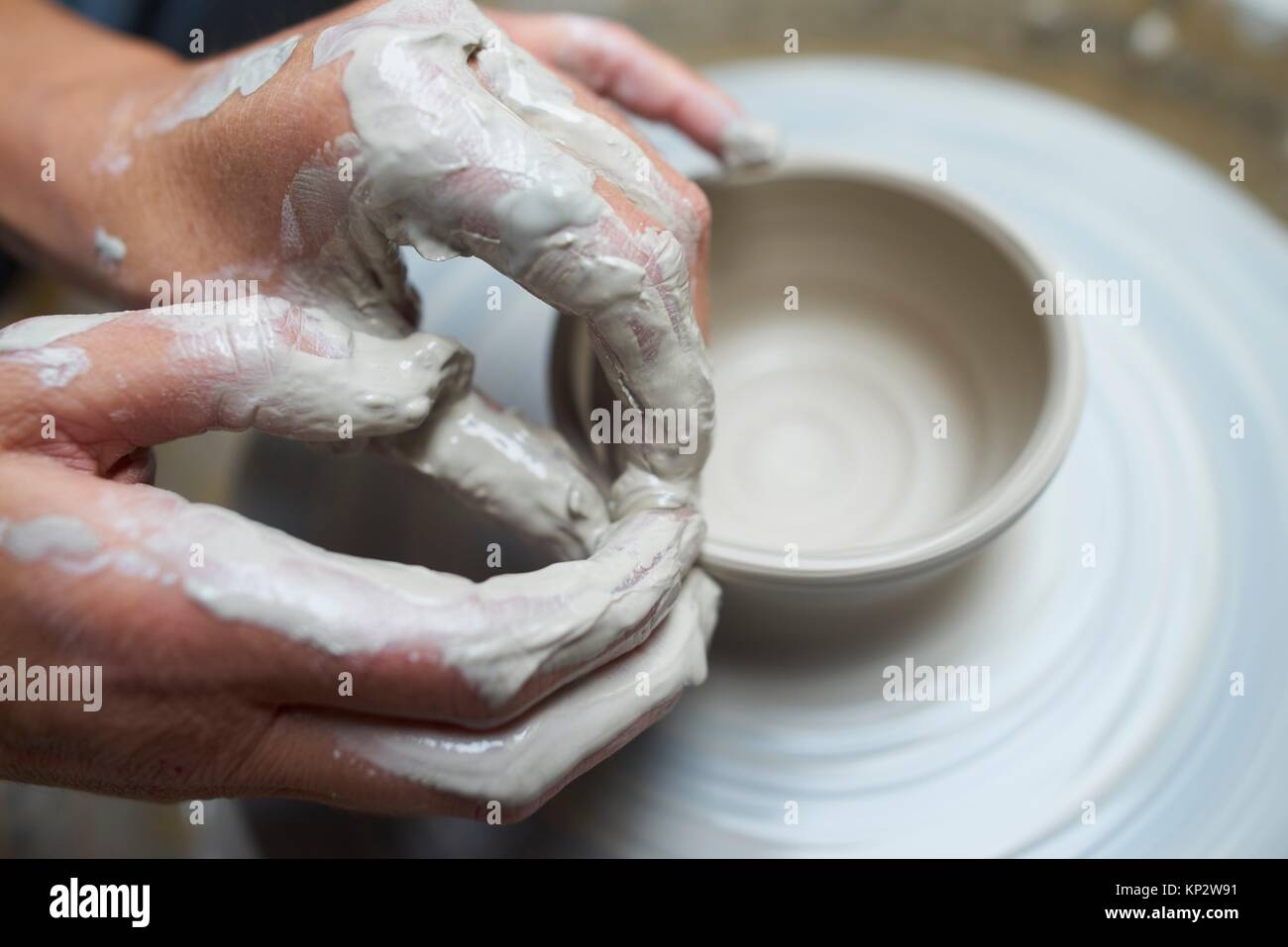 close-up of creative hands using clay to create pottery Stock Photo