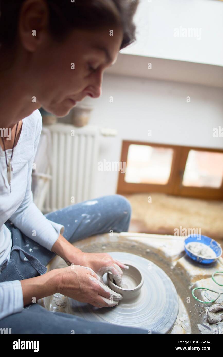 ardent mature woman creating pottery Stock Photo