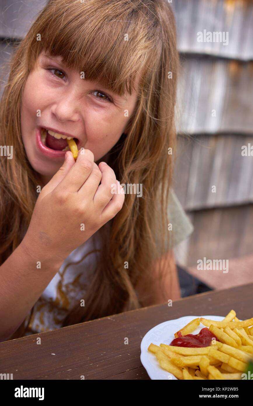 happy young girl eating French Fries with ketchup Stock Photo Alamy