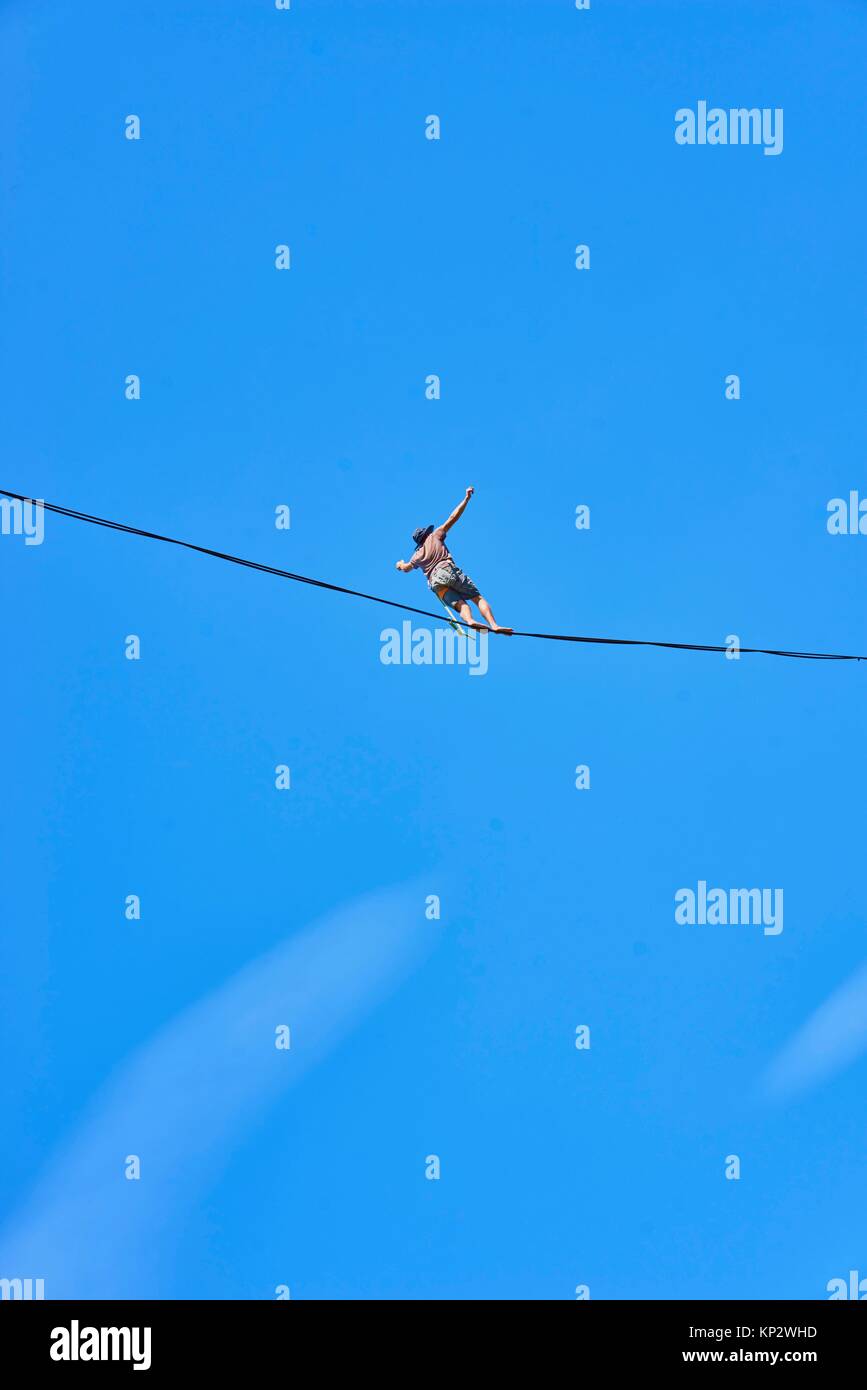 man walking on highline slackline in high heights, Bavarian alps, near