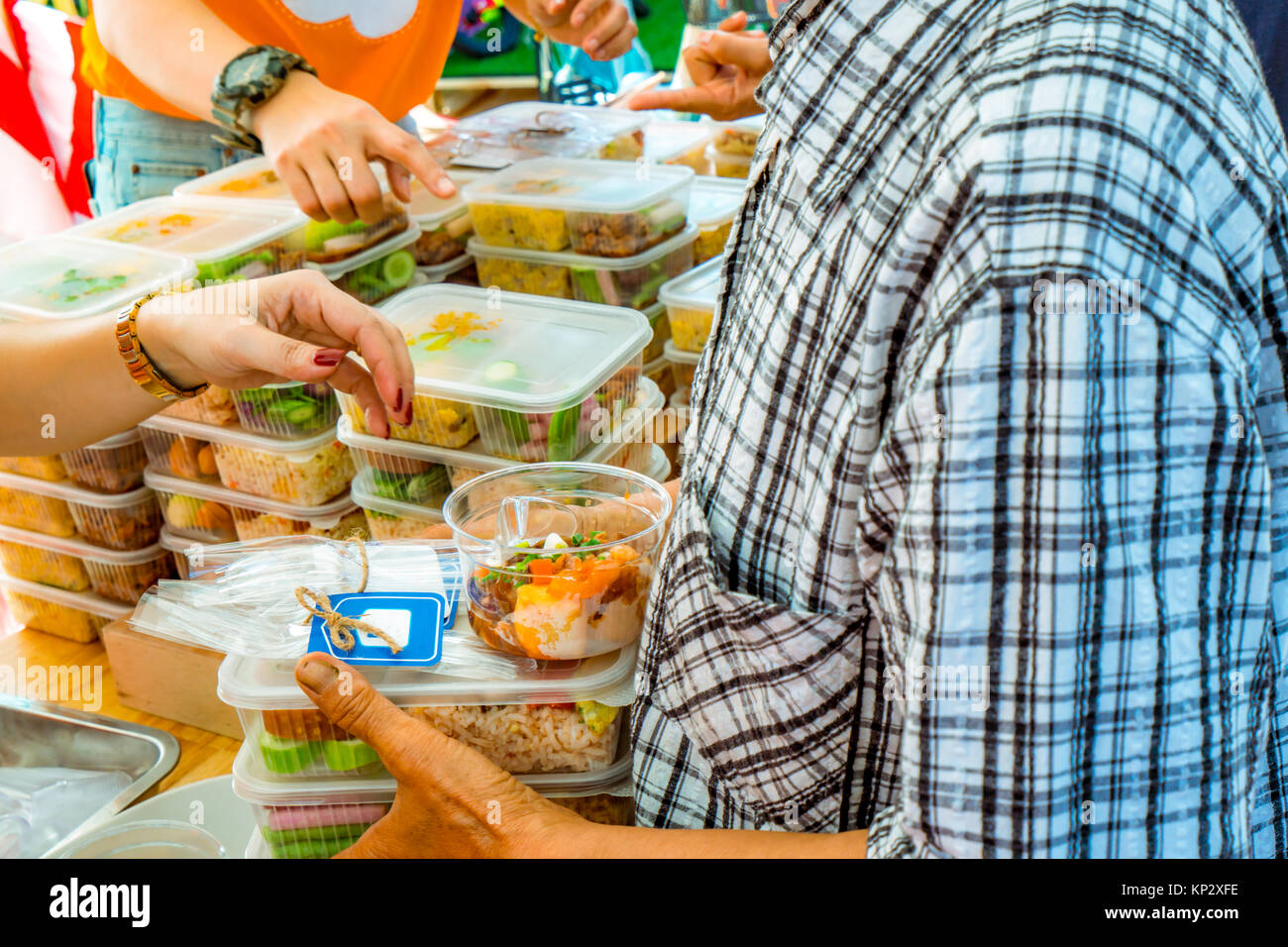 Volunteers giving food to poor people. Poverty concept. Private enterprise charities give food to the underprivileged. Stock Photo