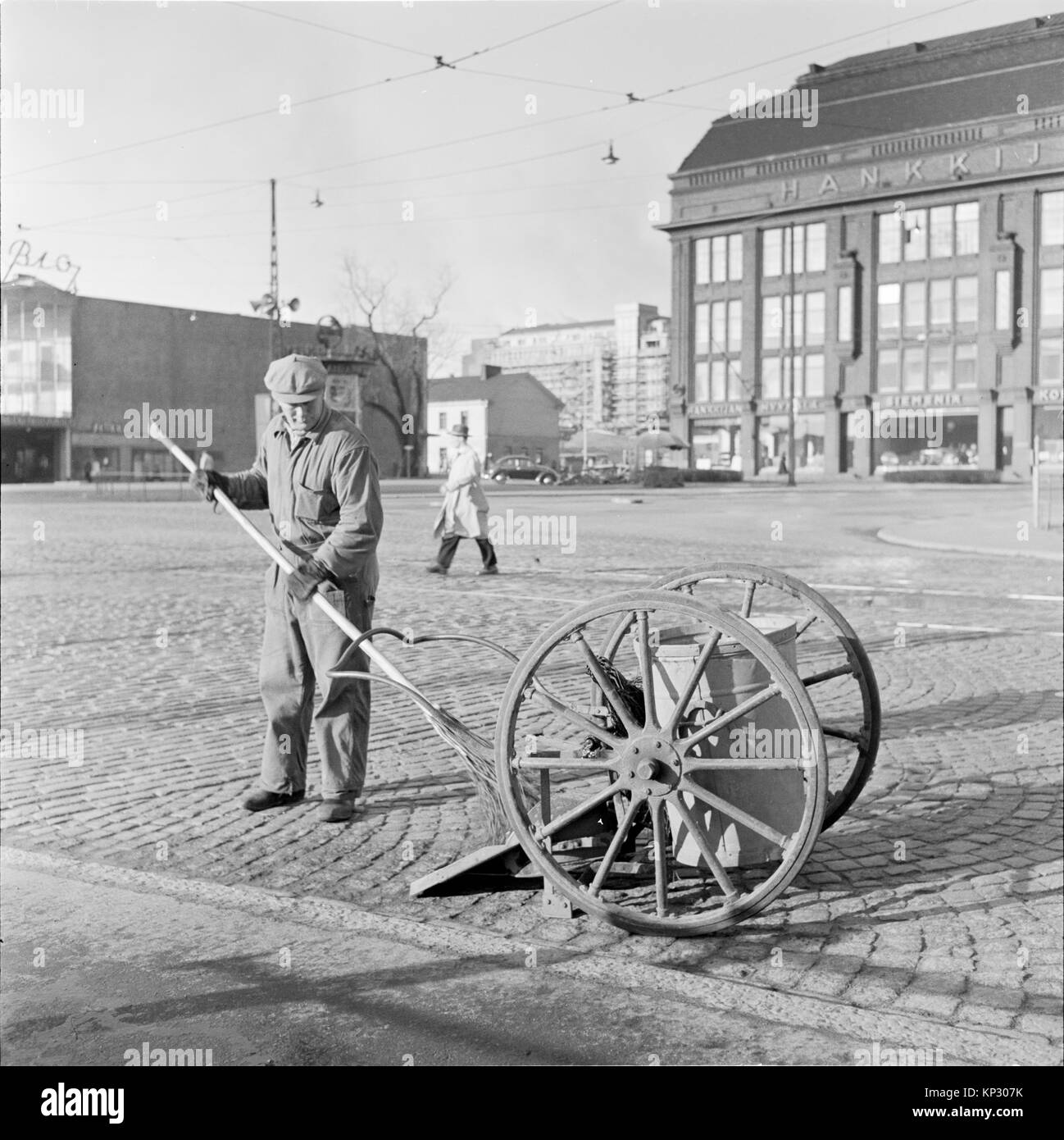 Male cleaner worker sweeping street Helsinki, Finland 1995 Stock Photo