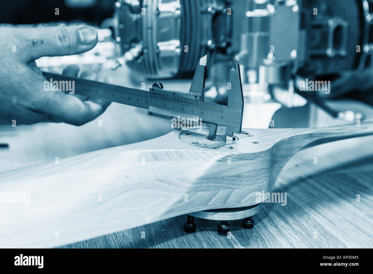 Measure the diameter of a wooden propeller bore through a sliding gauge