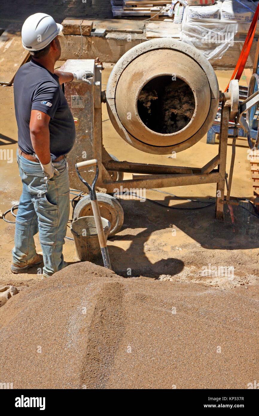 Construction worker with concrete mixing machine Stock Photo Alamy