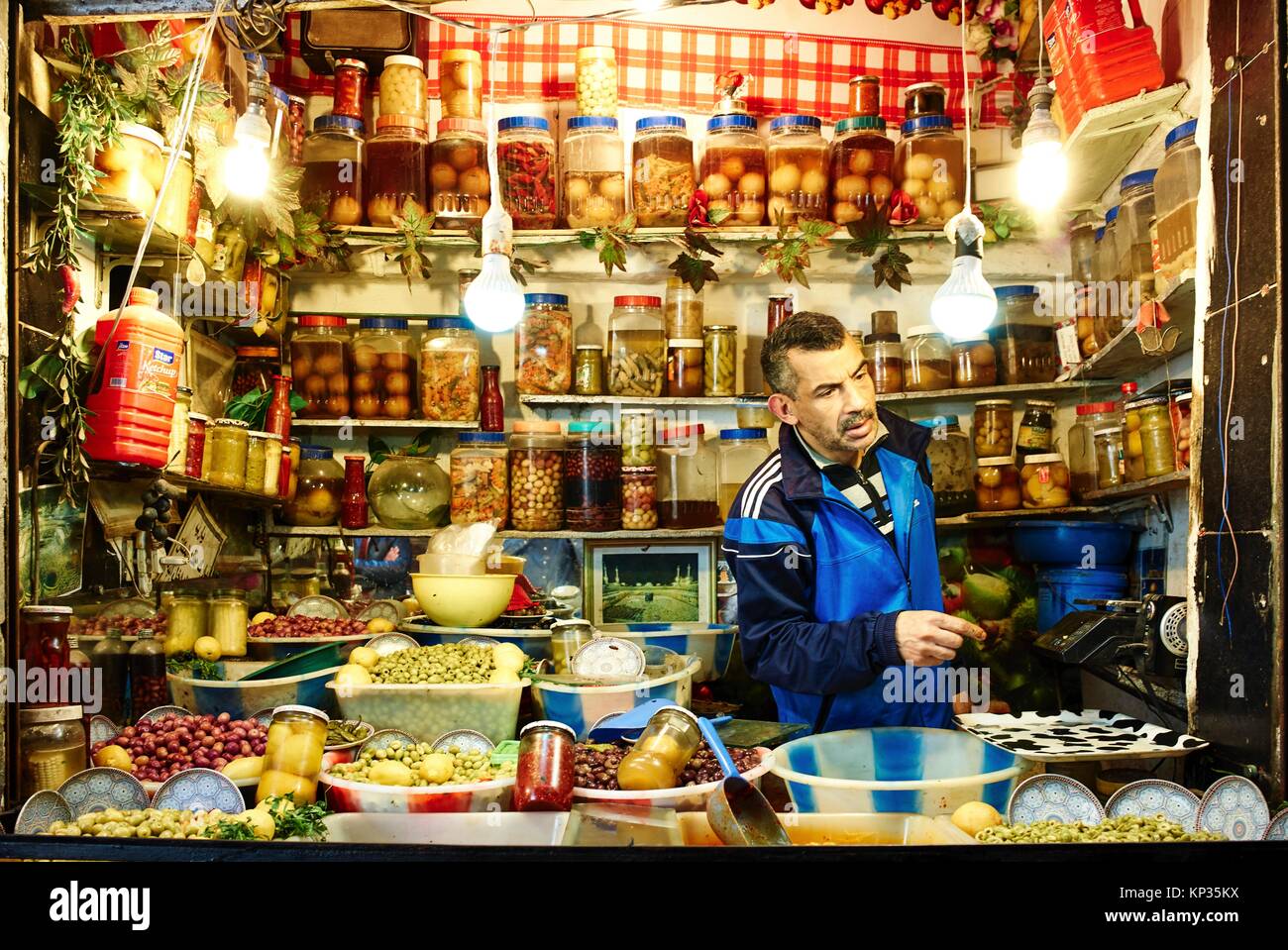 Selling olives in brine in a shop in the souk of Fez, Morocco Stock Photo