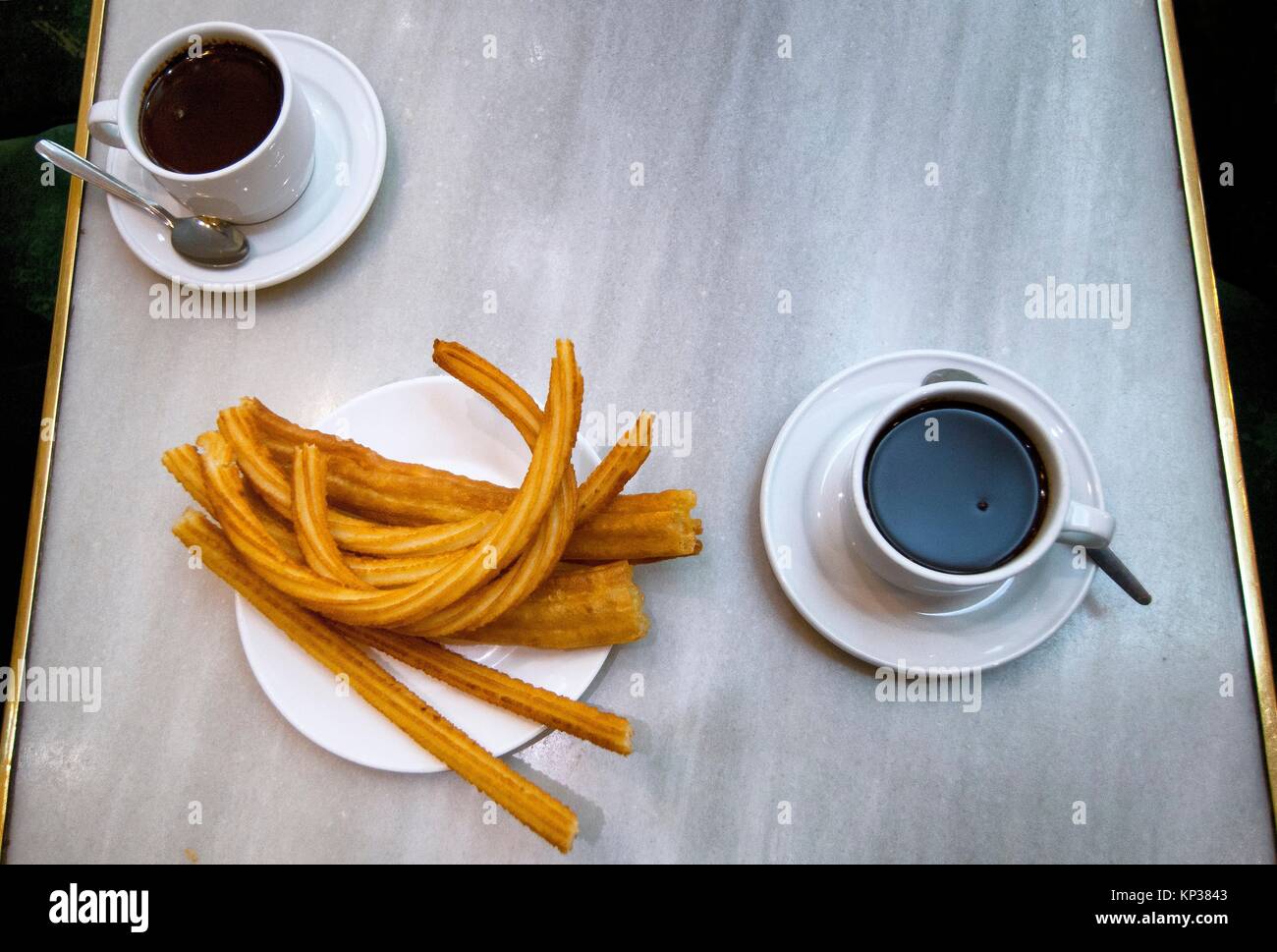 hot chocolate dipping sauce served in a cups and plate of churros, San Gines chocolateria in Madrid, Spain, Europe Stock Photo