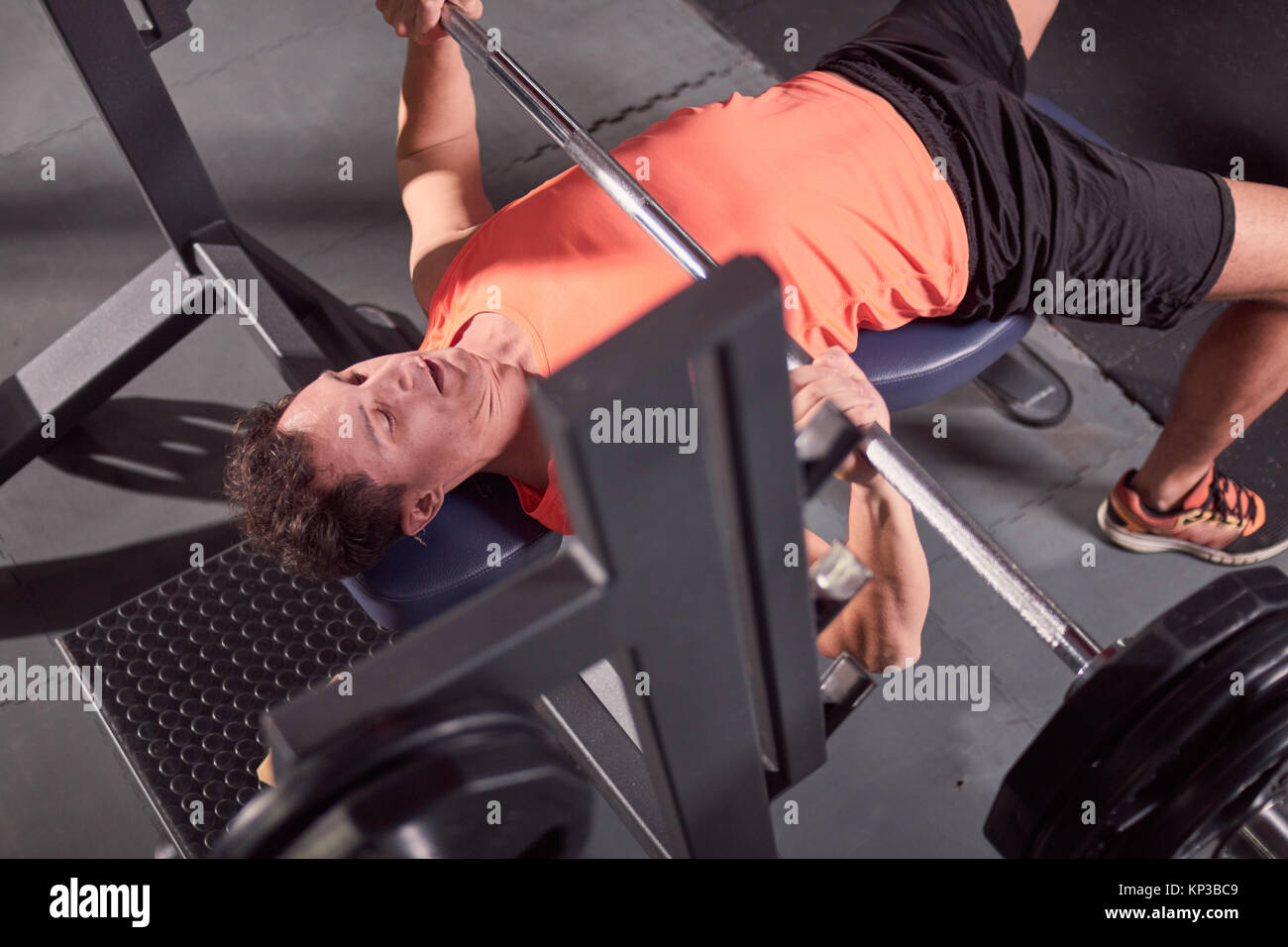 one person, young man, bench press, weight training, elevated view, view from above. Stock Photo