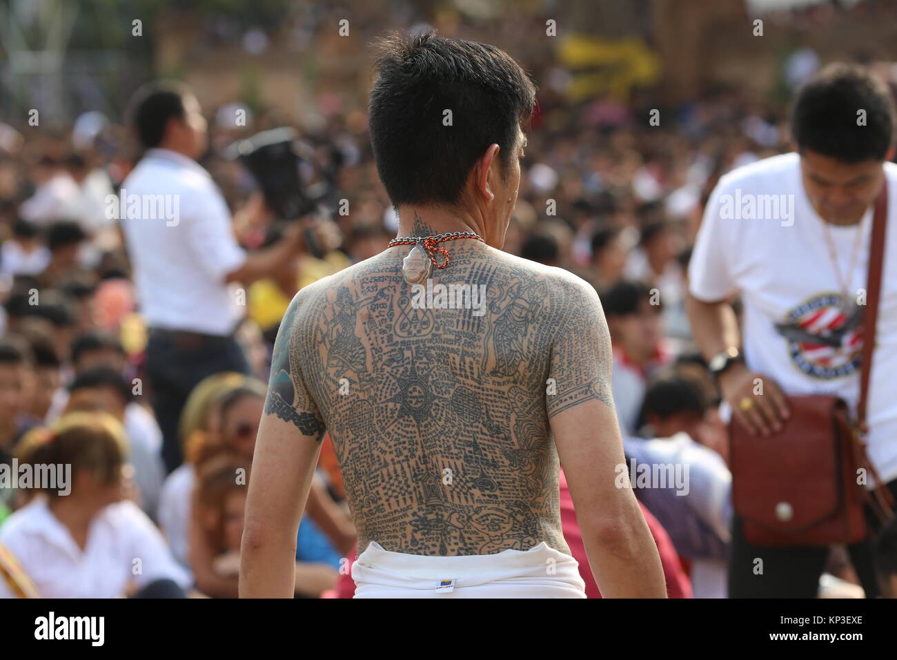 The annual Tattoo Festival at Wat Bang Phra allows those with temple tattoos to recharge their sacred powers of protection by the monks' blessing. Stock Photo