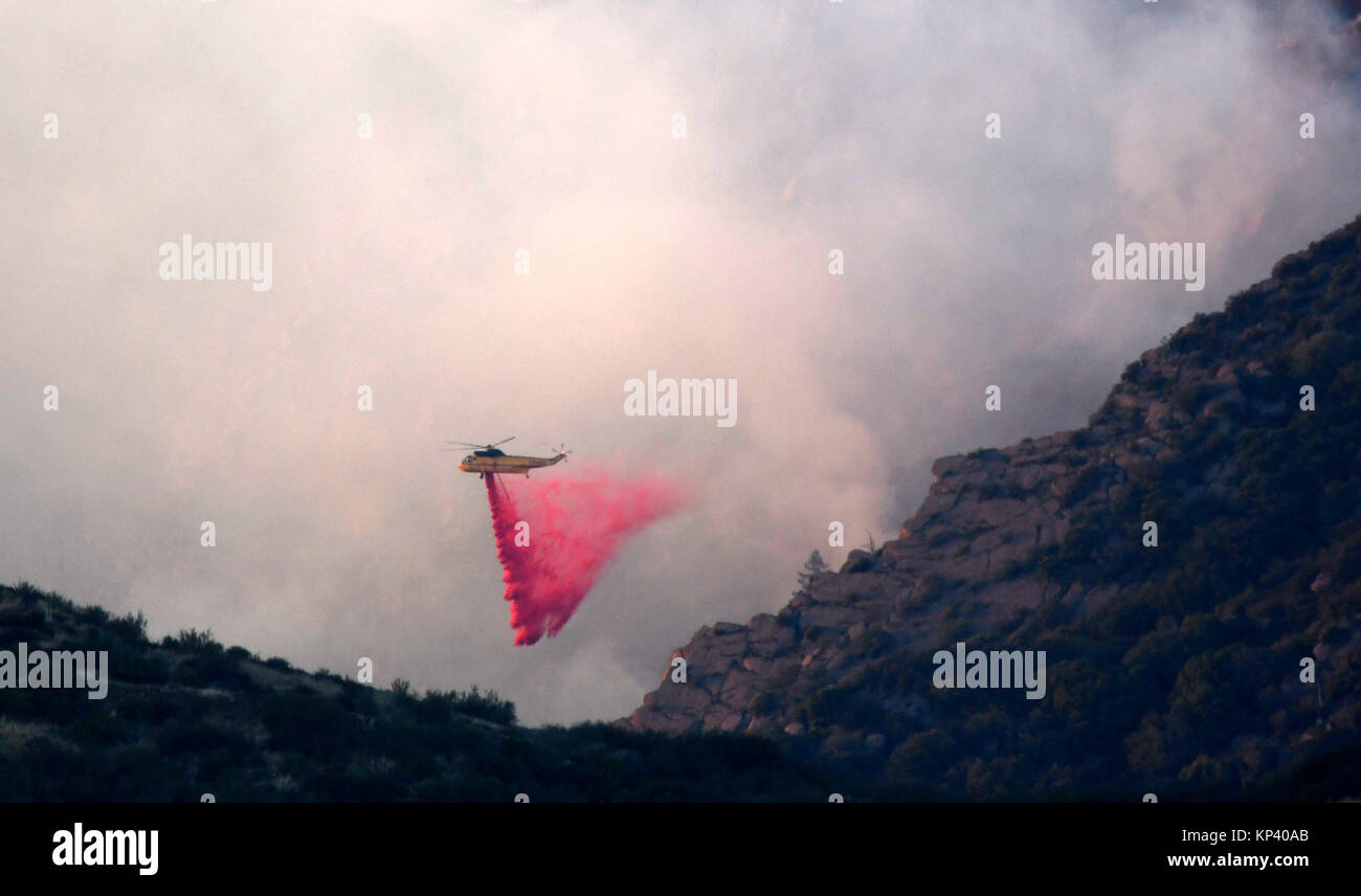 Fillmore, California, USA. 12th Dec, 2017. Fire helicopters make PhosChek drops to get control