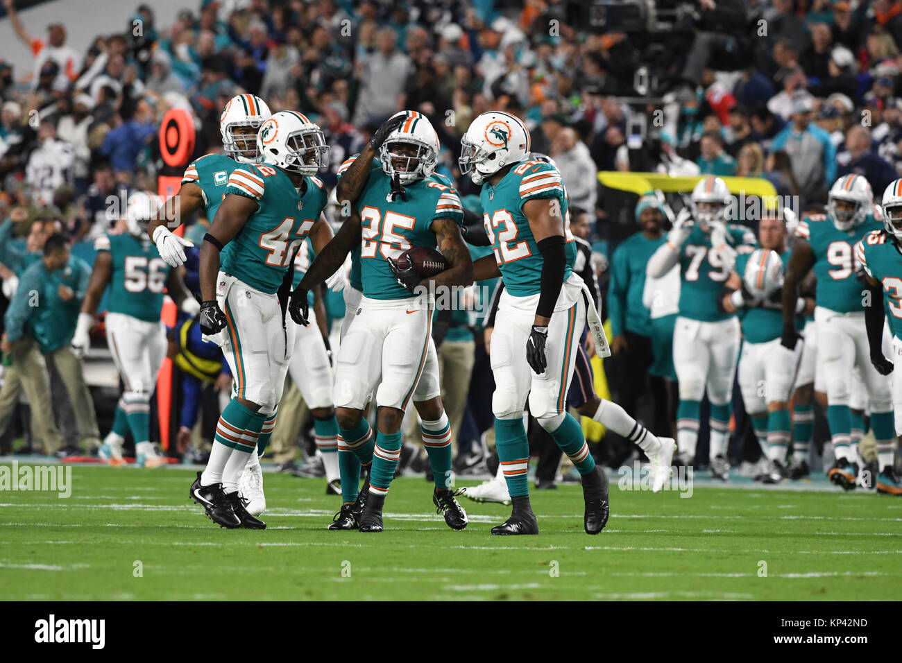 December 11, 2017: Xavien Howard #25 of Miami celebrates with Alterraun Verner #42 and T.J. McDonald #22 after intercepting a pass during the NFL football game between the Miami Dolphins and New England Patriots at Hard Rock Stadium in Miami Gardens FL. The Dolphins defeated the Patriots 27-20. Stock Photo
