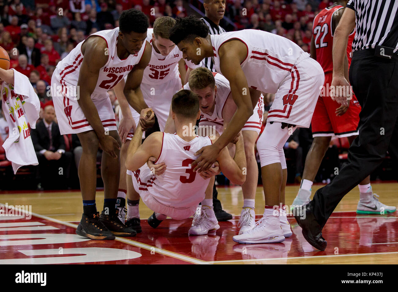 Madison, WI, USA. 13th Dec, 2017. Wisconsin Badgers guard Walt McGrory #3 is helped up by his teammates after being fouled going up for a shot during the NCAA Basketball game between the Western Kentucky Hilltoppers and the Wisconsin Badgers at the Kohl Center in Madison, WI. Wisconsin defeated Western Kentucky 81-80. John Fisher/CSM/Alamy Live News Stock Photo