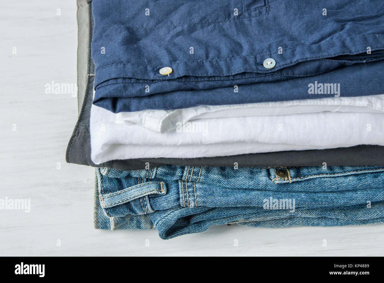 Stack Heap of Folded Jeans Cotton Pants and Shirts on White Wood Background  Shelf Closet Eco Fashion Authentic Classic Style Natural Materials  Unisex Stock Photo  Adobe Stock