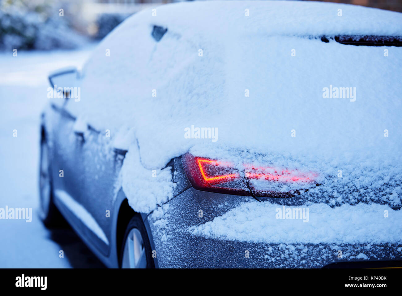 Snow covered car in winter conditions Stock Photo