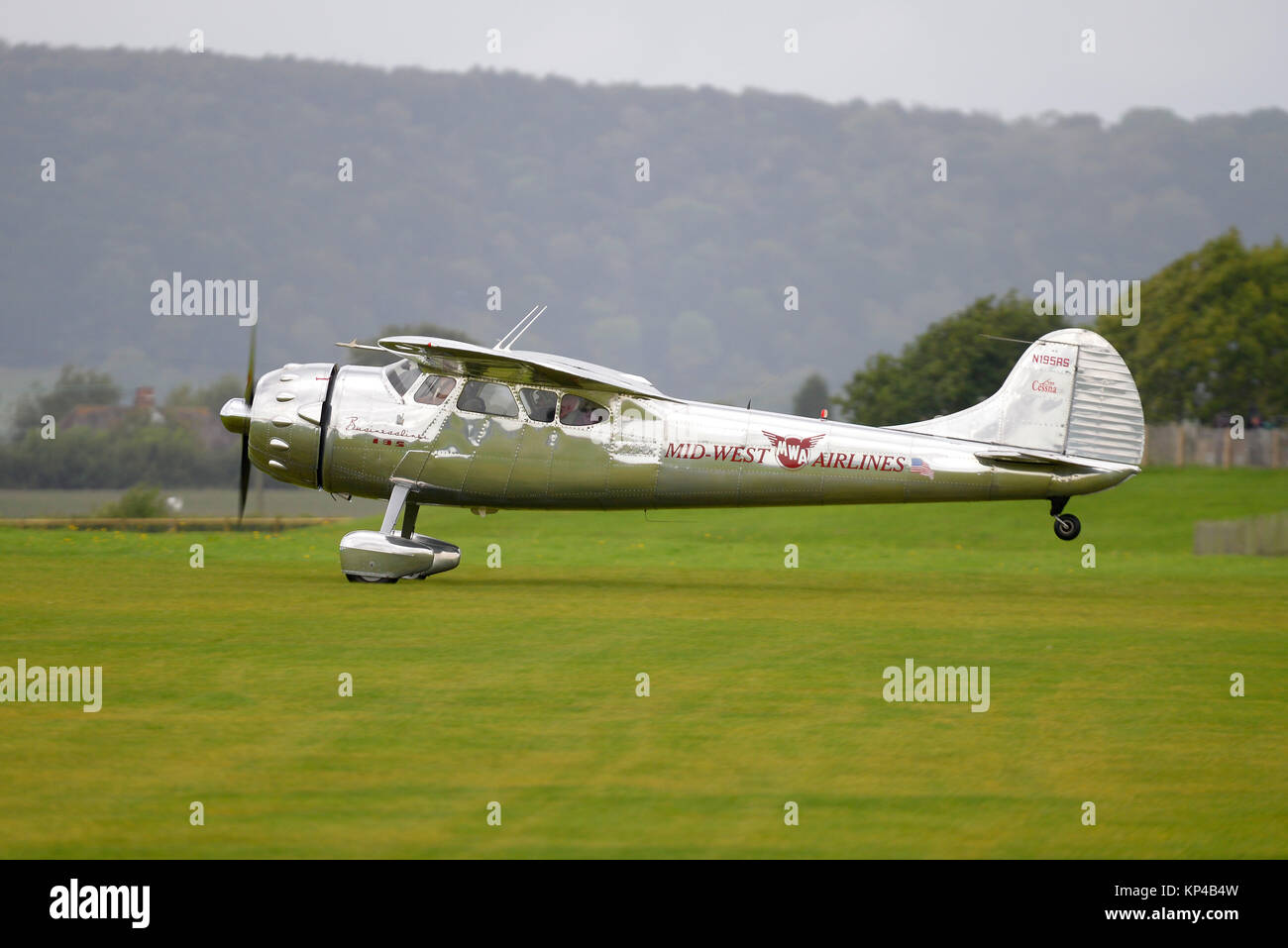 Cessna 195 Businessliner N195RS marked Mid West Airlines taking off at Goodwood Revival 2017 Stock Photo