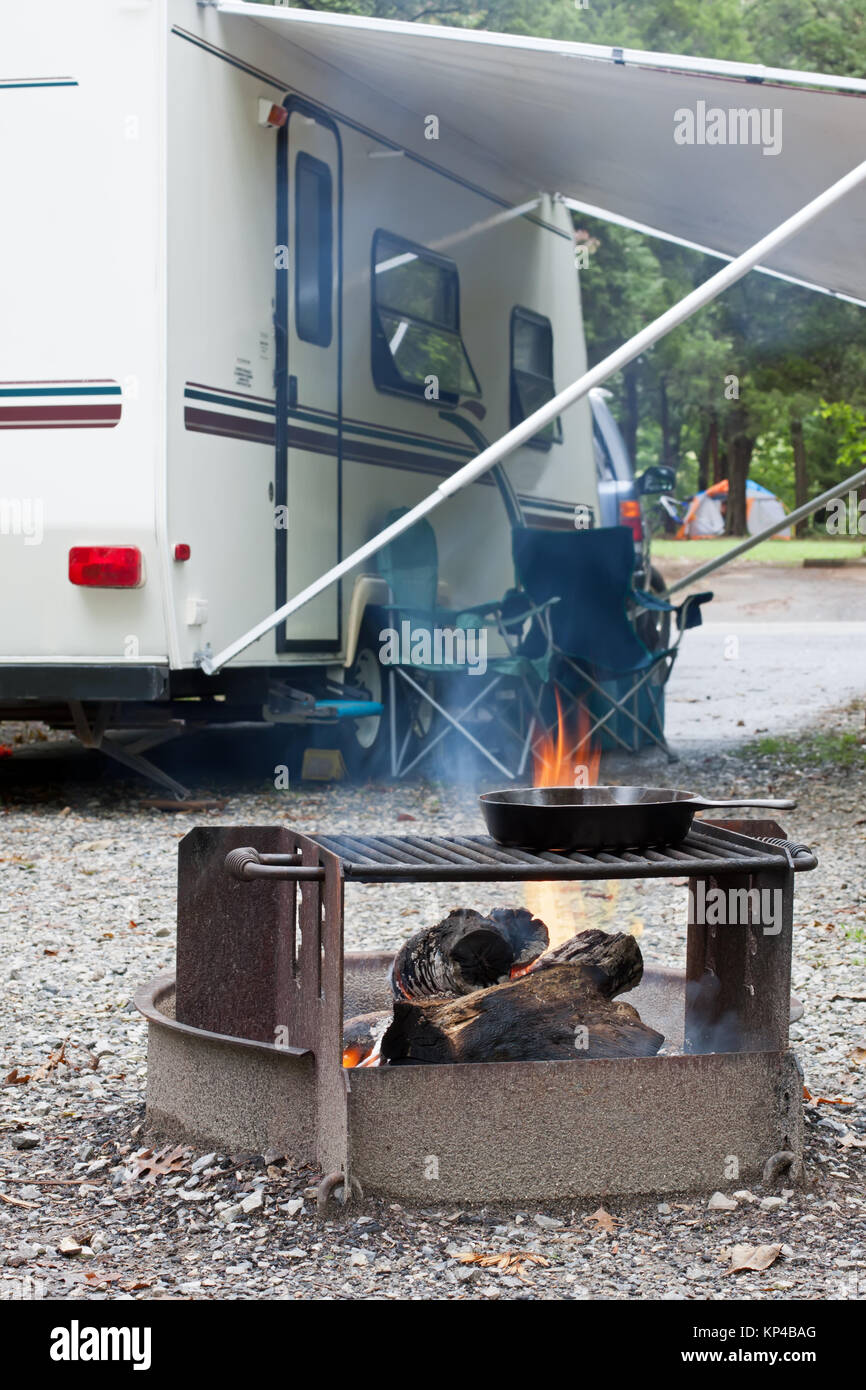 An outdoor grill at a Pennsylvania State Park with a camping trailer in the background. Stock Photo