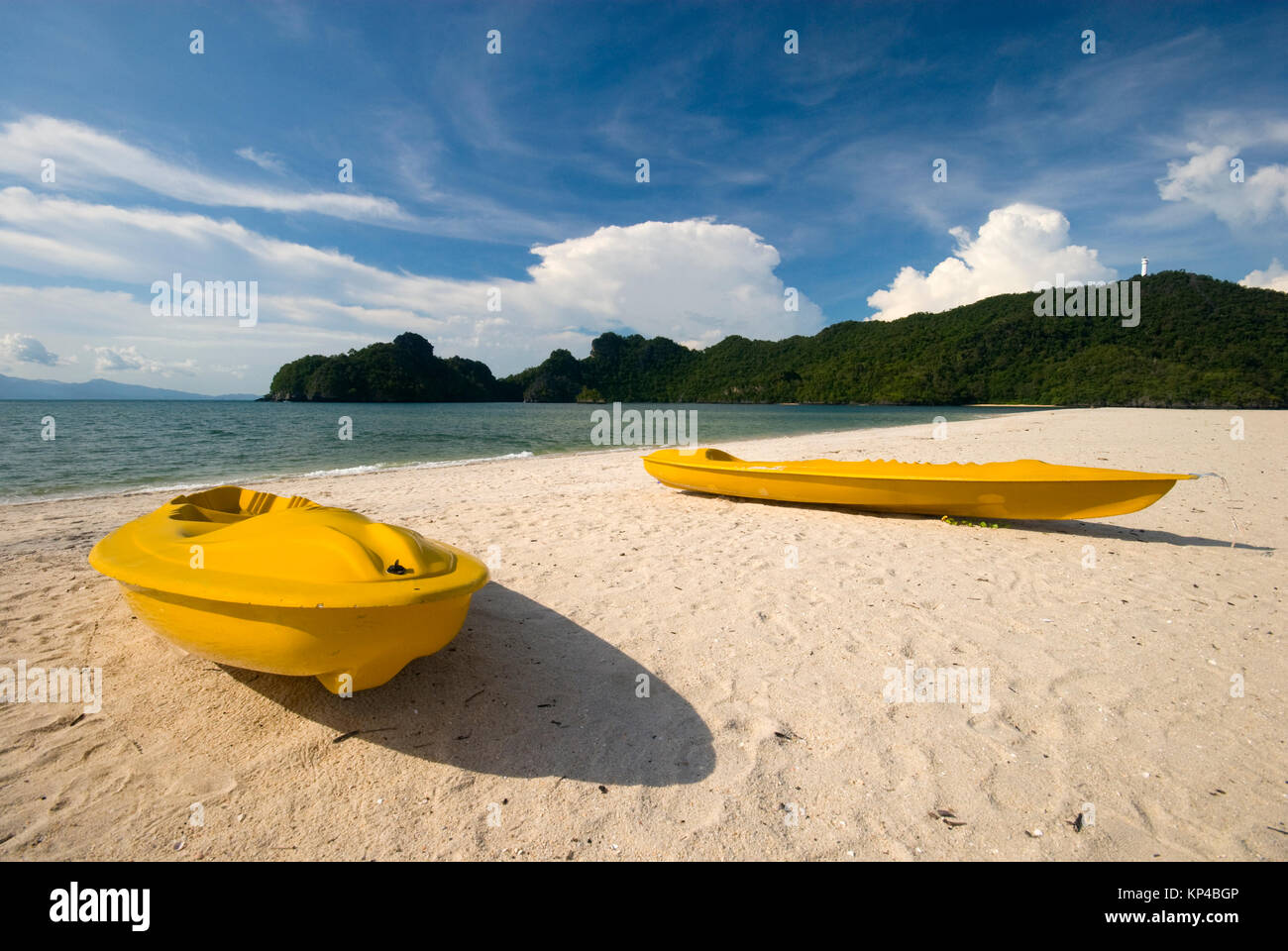 Yellow kayaks on an empty beach Stock Photo - Alamy