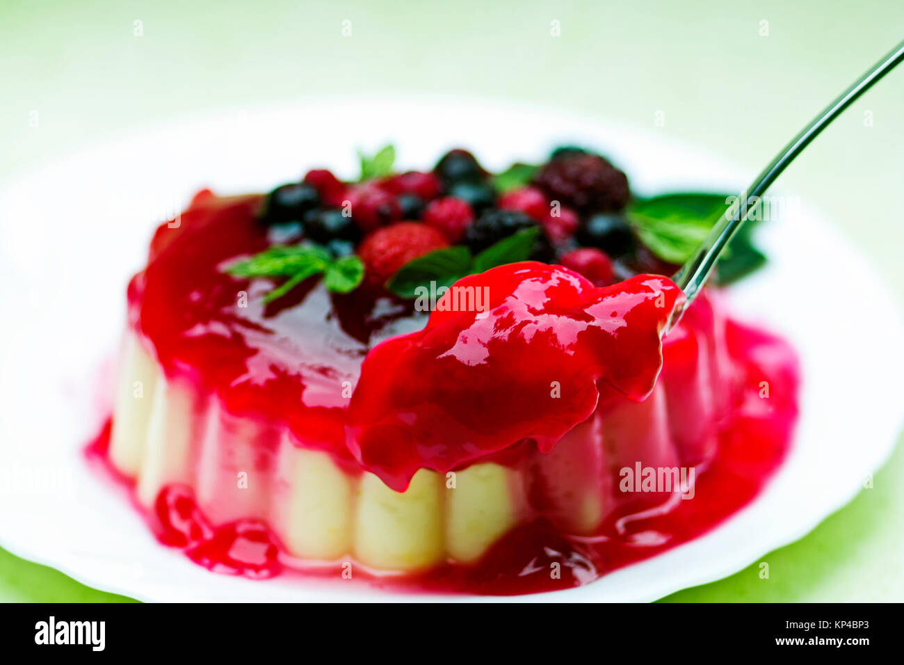 Vanilla pudding with red groats and berries garnishes Stock Photo - Alamy