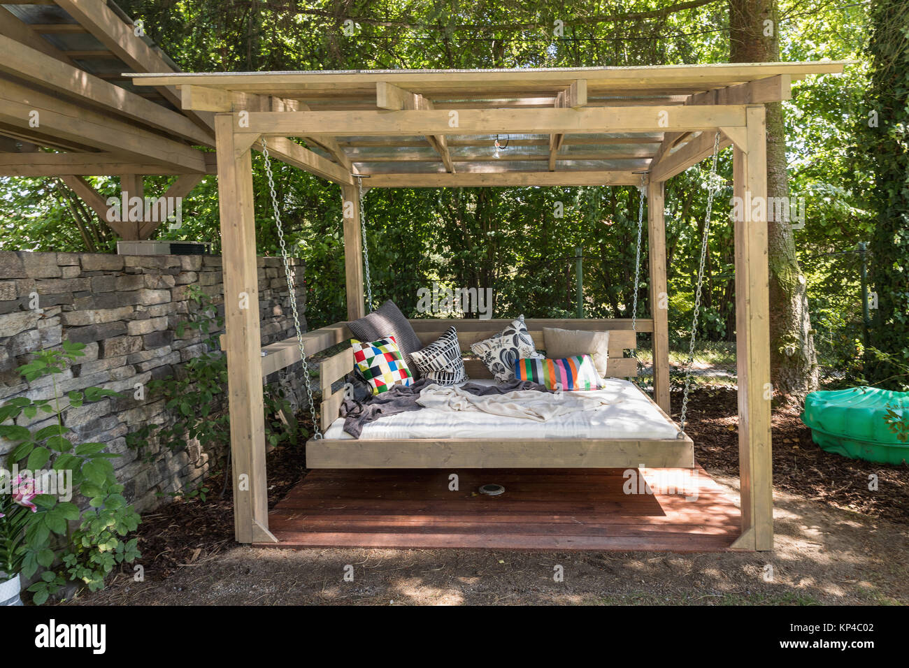 Big Swing Outdoor Bed Chaise Longue In The Garden In The Pergola Garden Bed With Pillows Big Outdoor Bed For Sunbathing And Rest Four Garden Bed Stock Photo Alamy