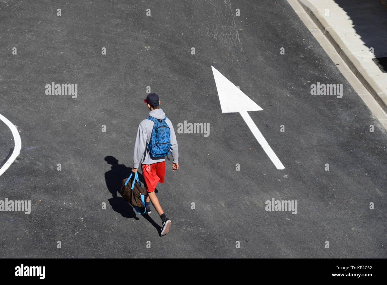 Man Walking Down Street Following Directional Arrow Aigues-Mortes, Gard, France Stock Photo