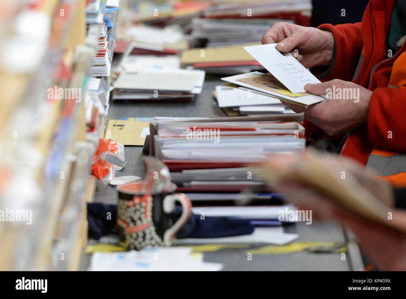 Workers sort cards and letters at the Royal Mail Peterborough Mail ...