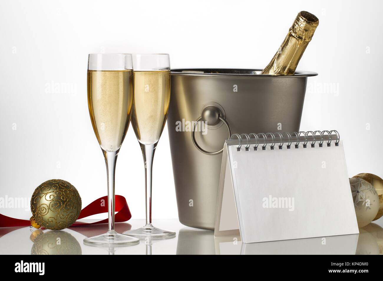 champagne bottle flutes and ice bucket with christmas baubles
