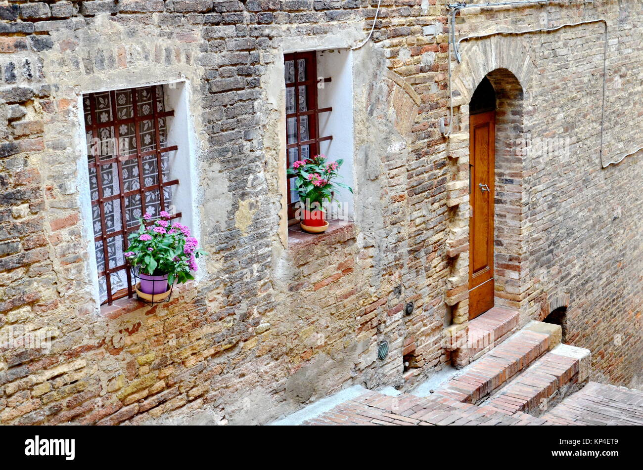 Stone and brick walls in the hill town of San Gimignano, Tuscany, Italy Stock Photo