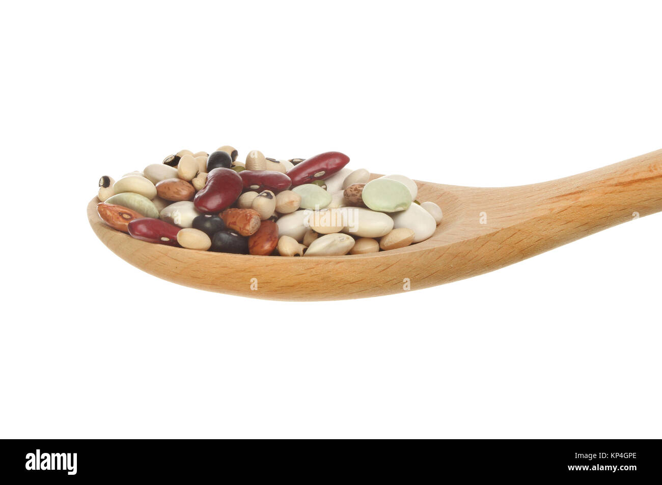 Mix of dried beans in a wooden spoon isolated against white Stock Photo