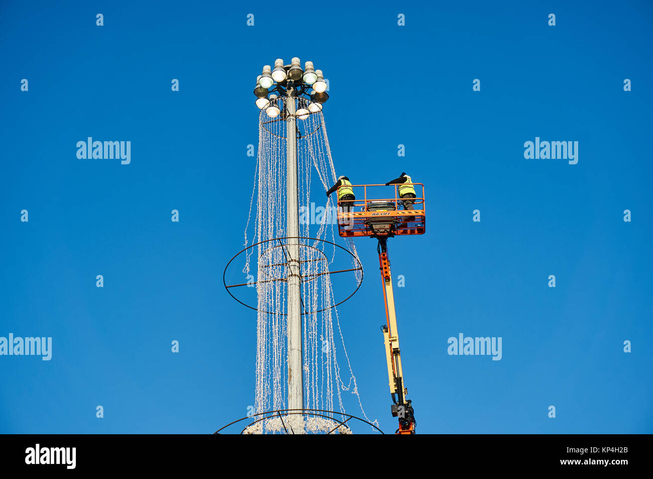 Engineers working at height on an elevated platform. Stock Photo