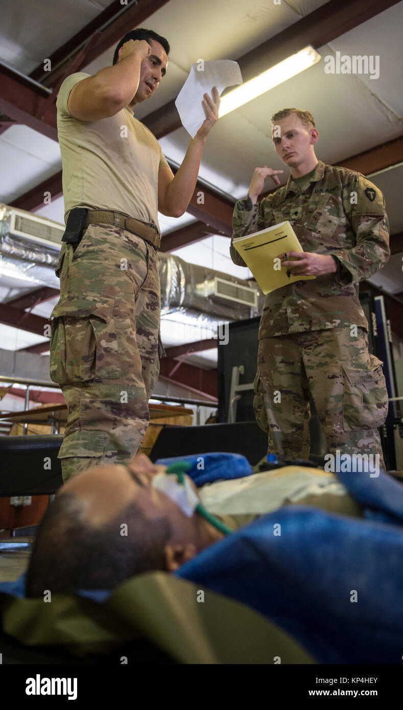 U.S. Air Force Staff Sgt. Julio Rojas (left), assigned to the 870th  Aeromedical Evacuation Squadron, simulates calling for a medical evacuation  as U.S. Army Spc. Alexander Kahanek, an instructor assigned to the