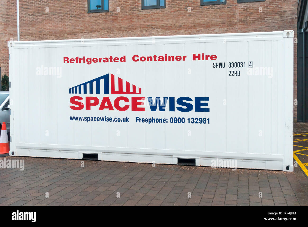 Spacewise brand 20 foot  size refrigerated transport container used for food storage behind a supermarket Stock Photo