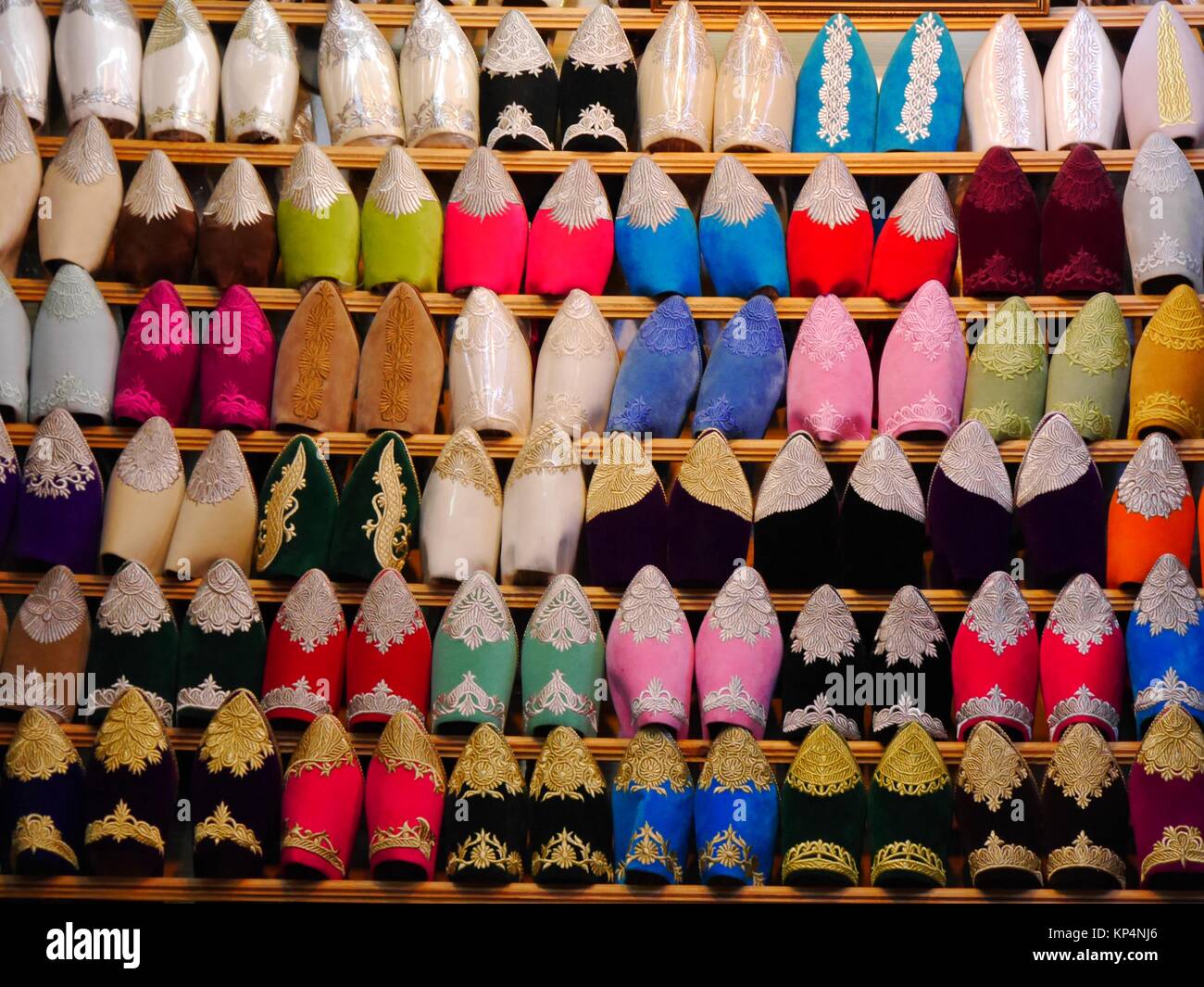 Close up of rows of babouches shoes in different colours on display in a stall in the souk of Fez, Morocco Stock Photo