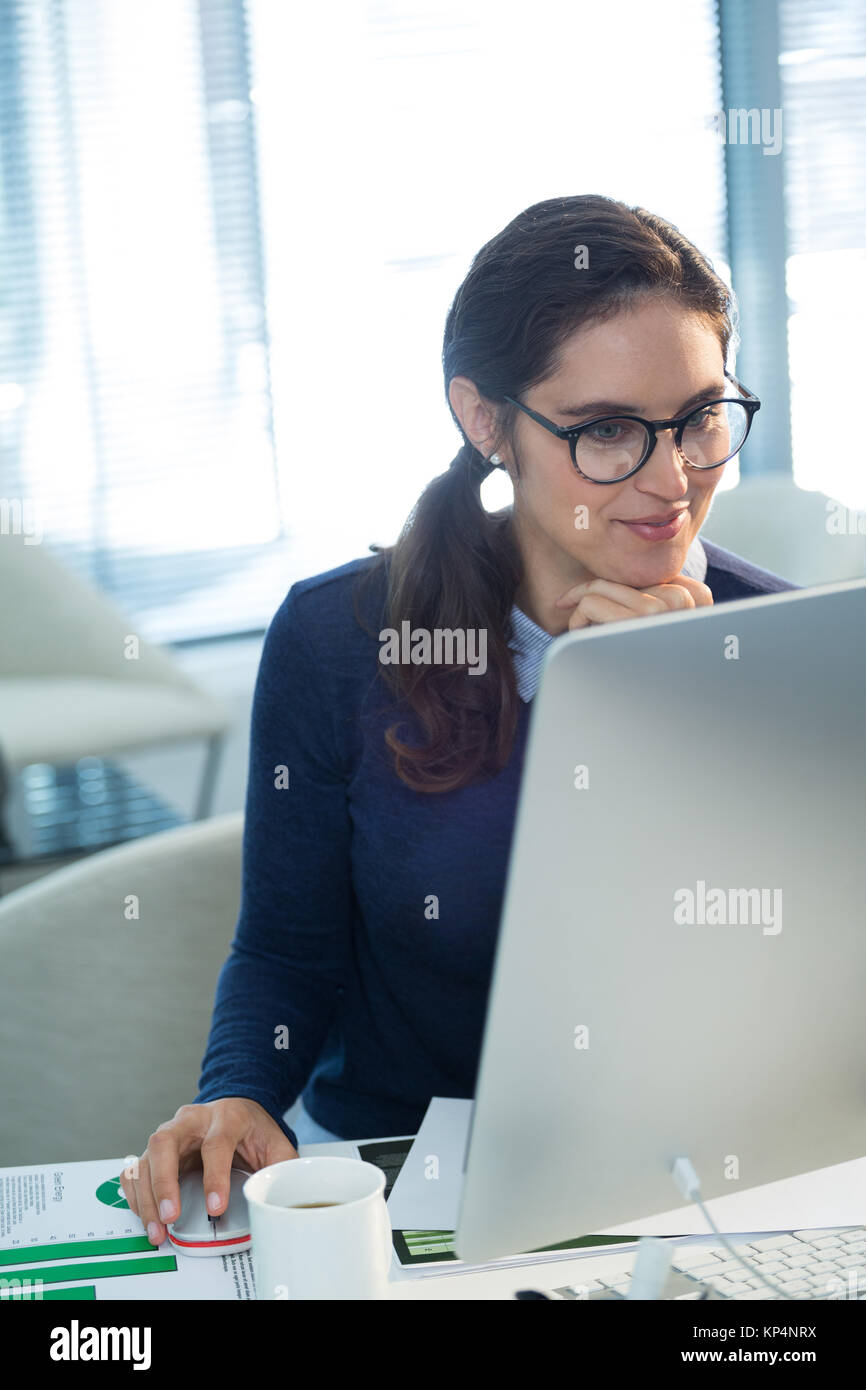 Female executive working on computer in office Stock Photo - Alamy