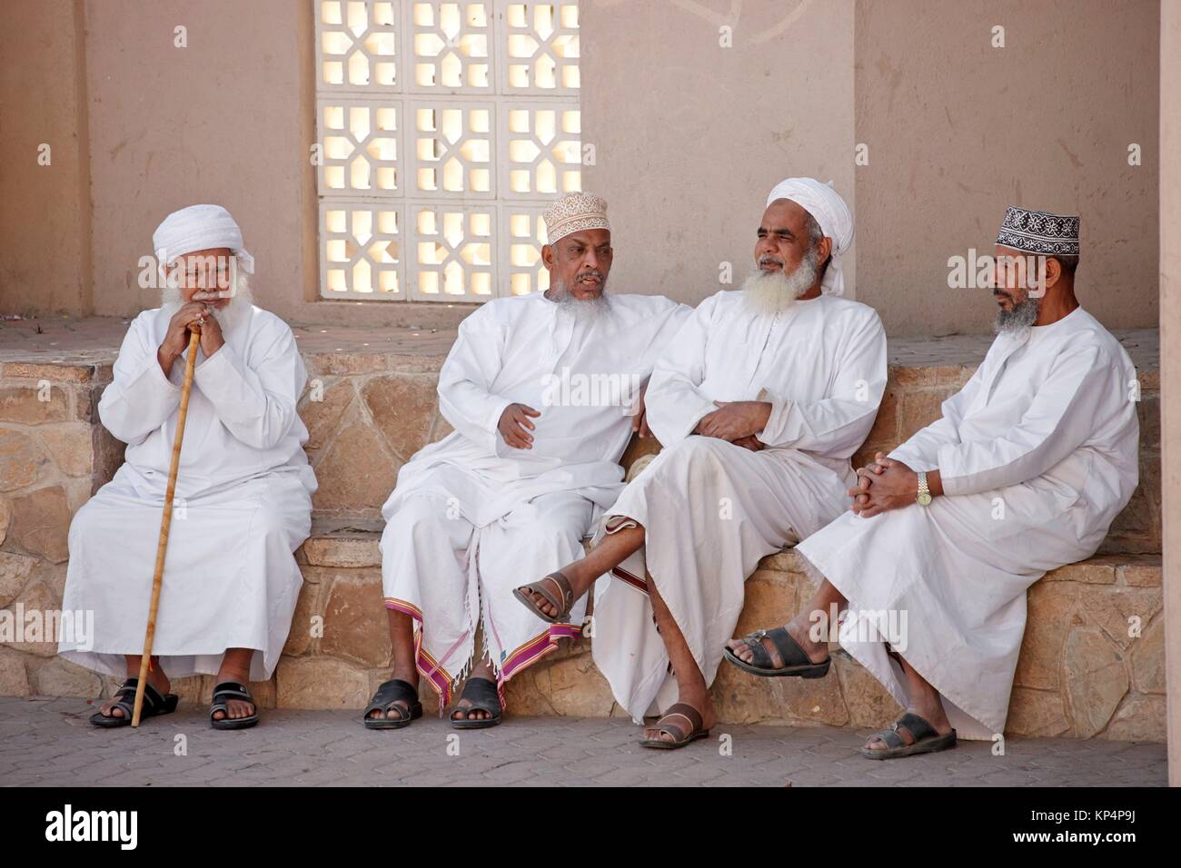Old men hanging out at Nizwa souk, Nizwa, Oman. Stock Photo