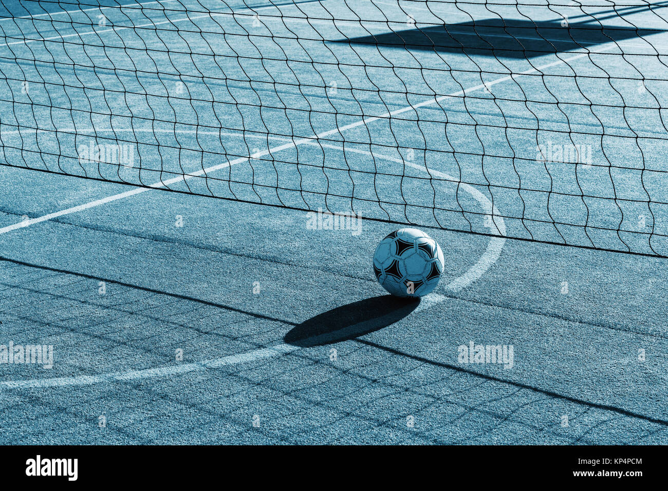 Outdoor playground for tennis, volleyball and football. Net and soccer ball on the playground. Futnet. Stock Photo