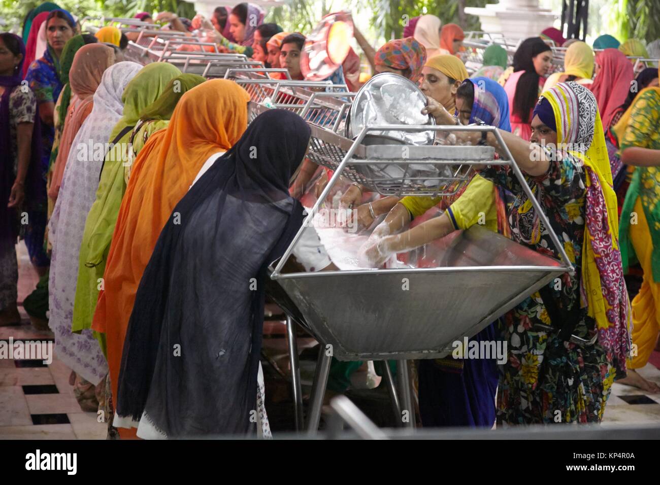 Women cleaning eating utensils. Dining Hall, Harmandir Sahib, Golden