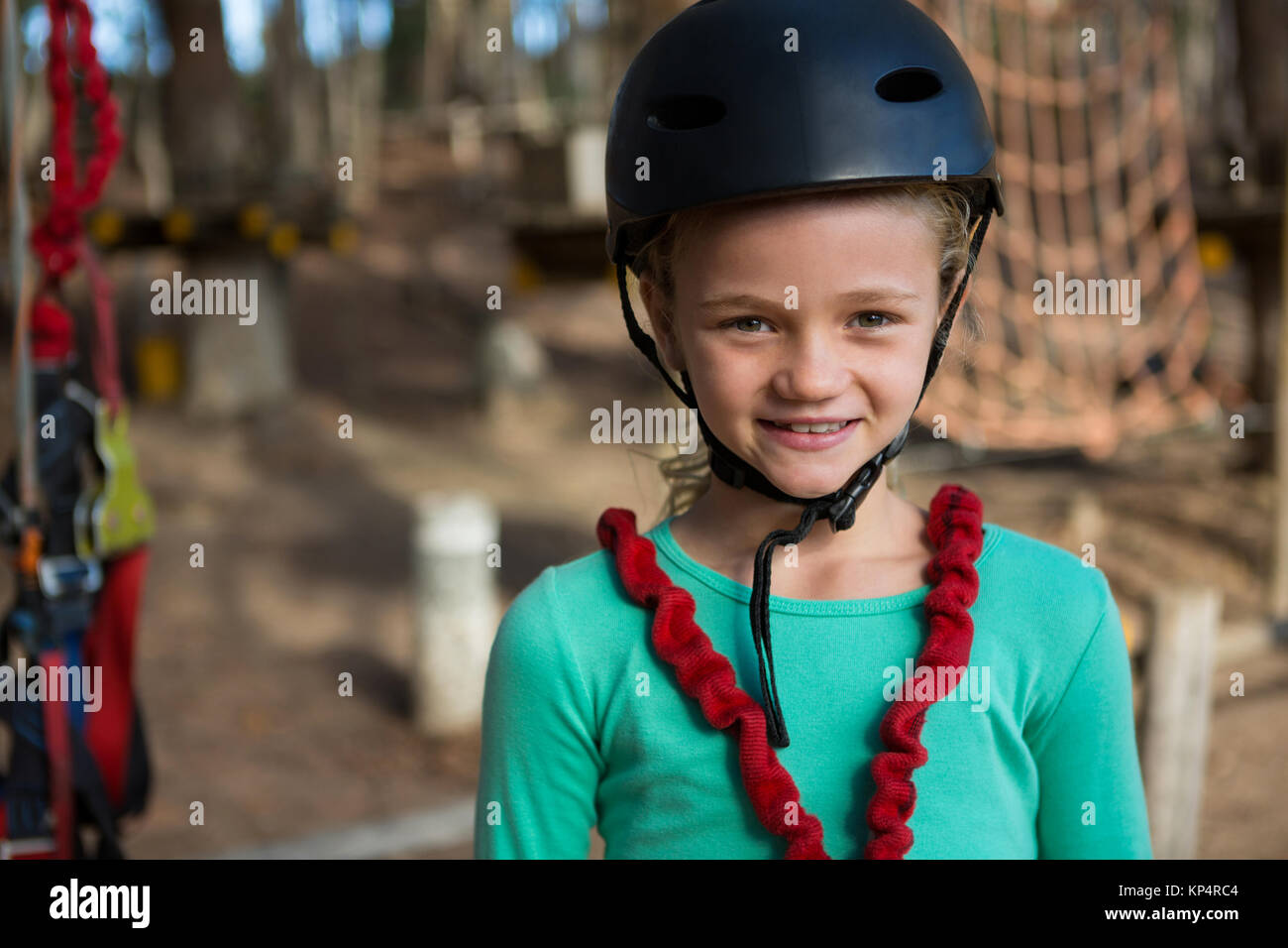 Close-up portrait of little girl wearing helmet and harness Stock Photo