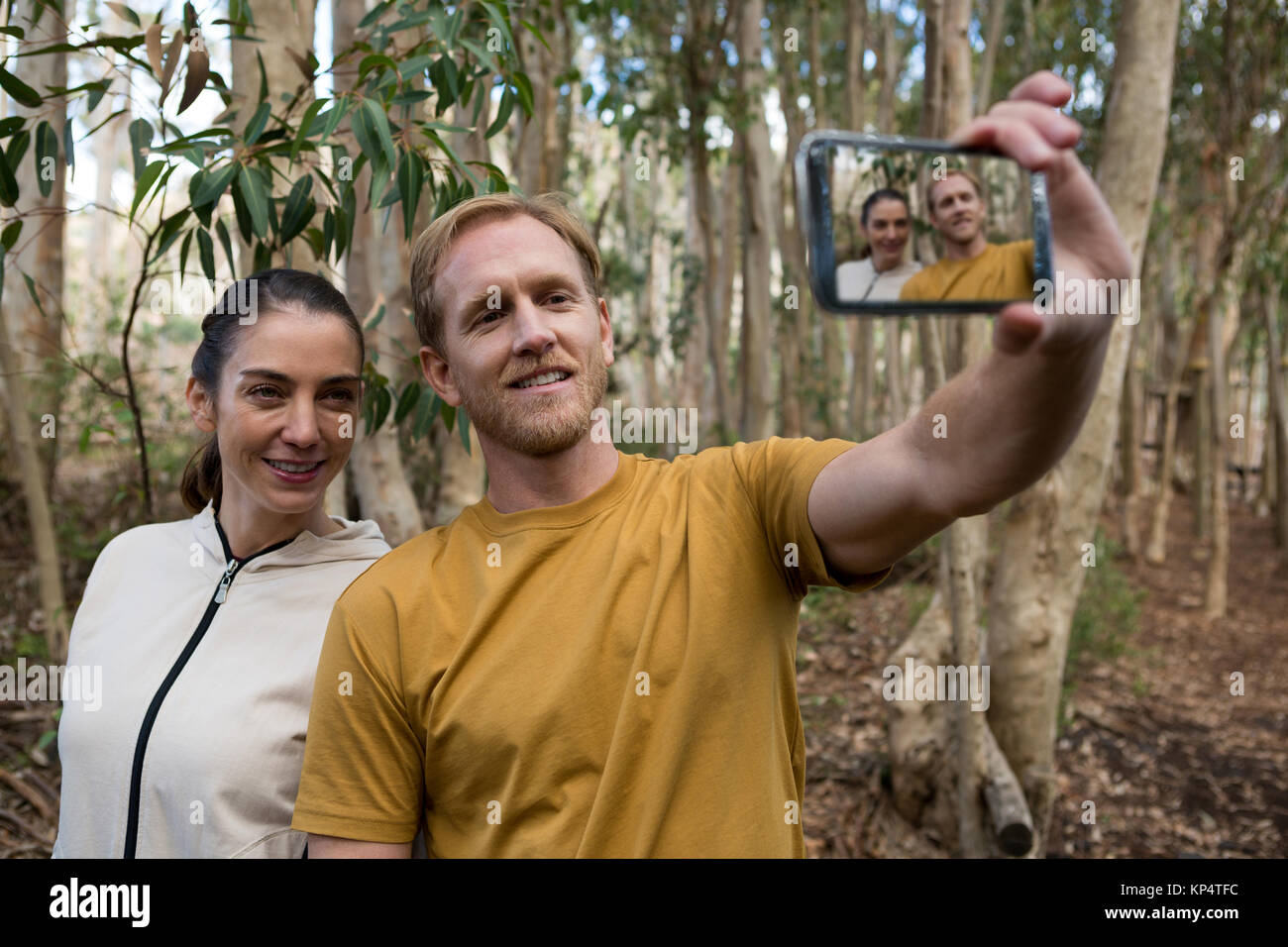 Smiling hiker couple taking selfie in the forest Stock Photo - Alamy