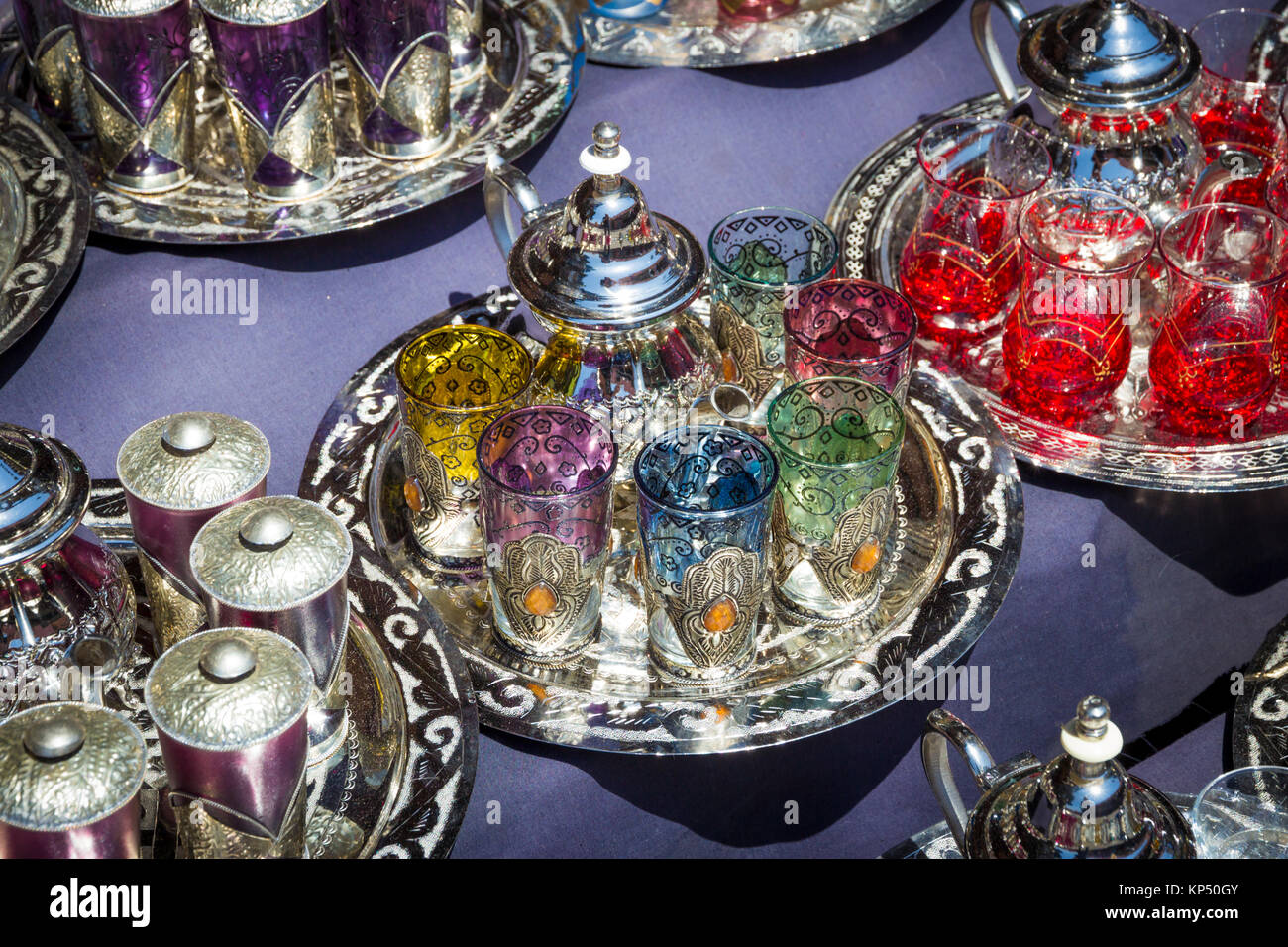 Traditional tea pots with tea glasses on a tray sold in the souks of Marrakesh, Morocco Stock Photo