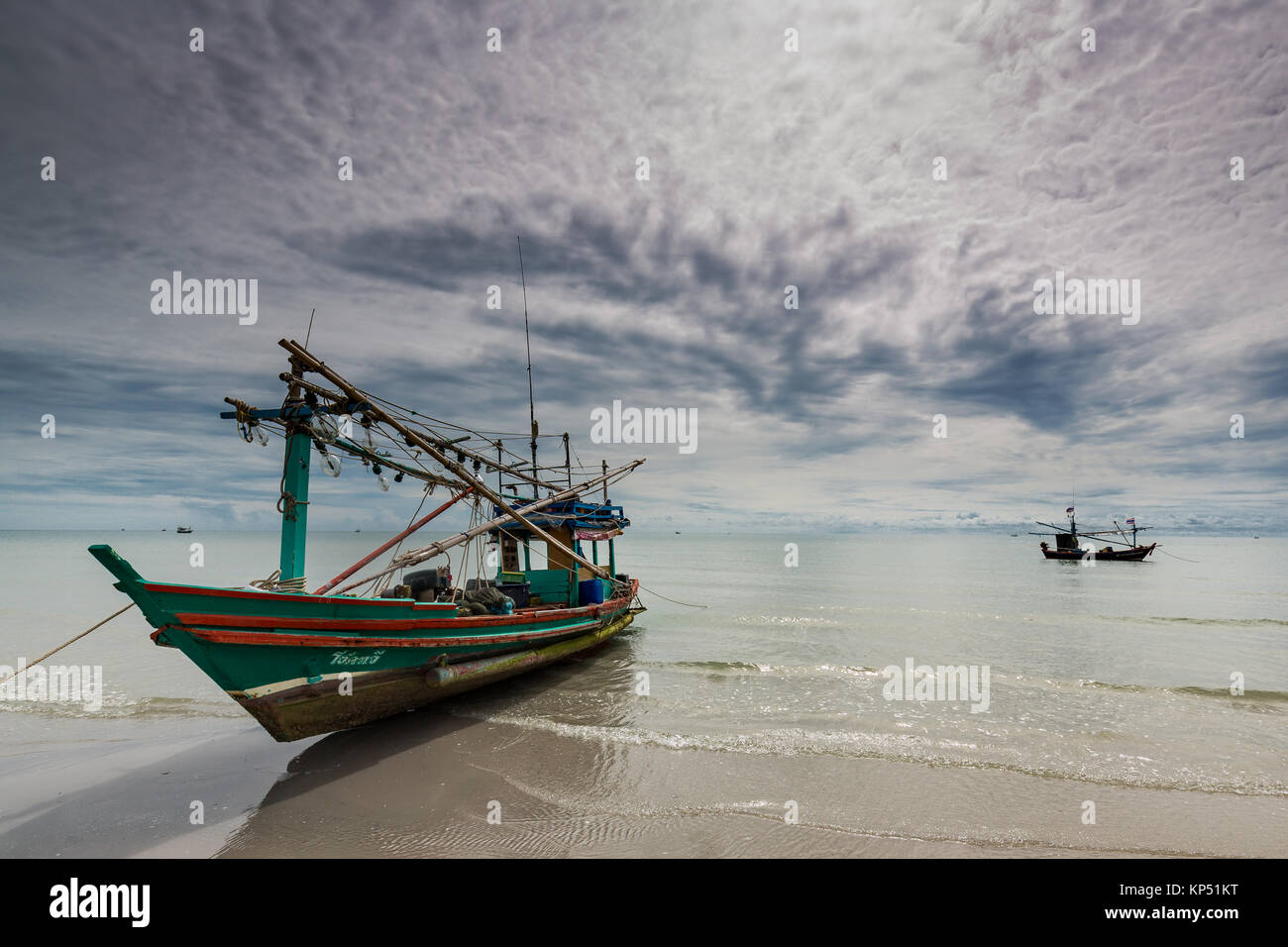 Old fishing boat in Khao Takiab close to Hua Hin in Thailand. Hua Hin is 2-3 hours drive south of Bangkok. It's a popular beach destination. Stock Photo