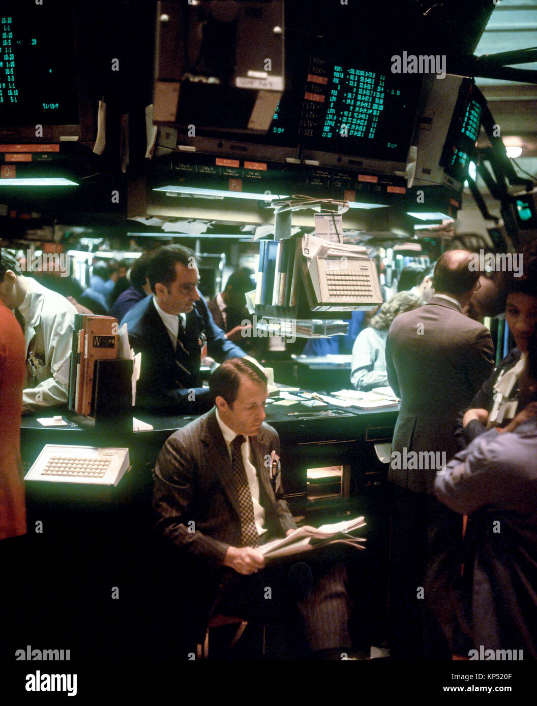 May 1982,New York,NYSE,Stock Exchange interior,trading floor,broker reading newspaper,Manhattan,New york City,NY,NYC,USA, Stock Photo