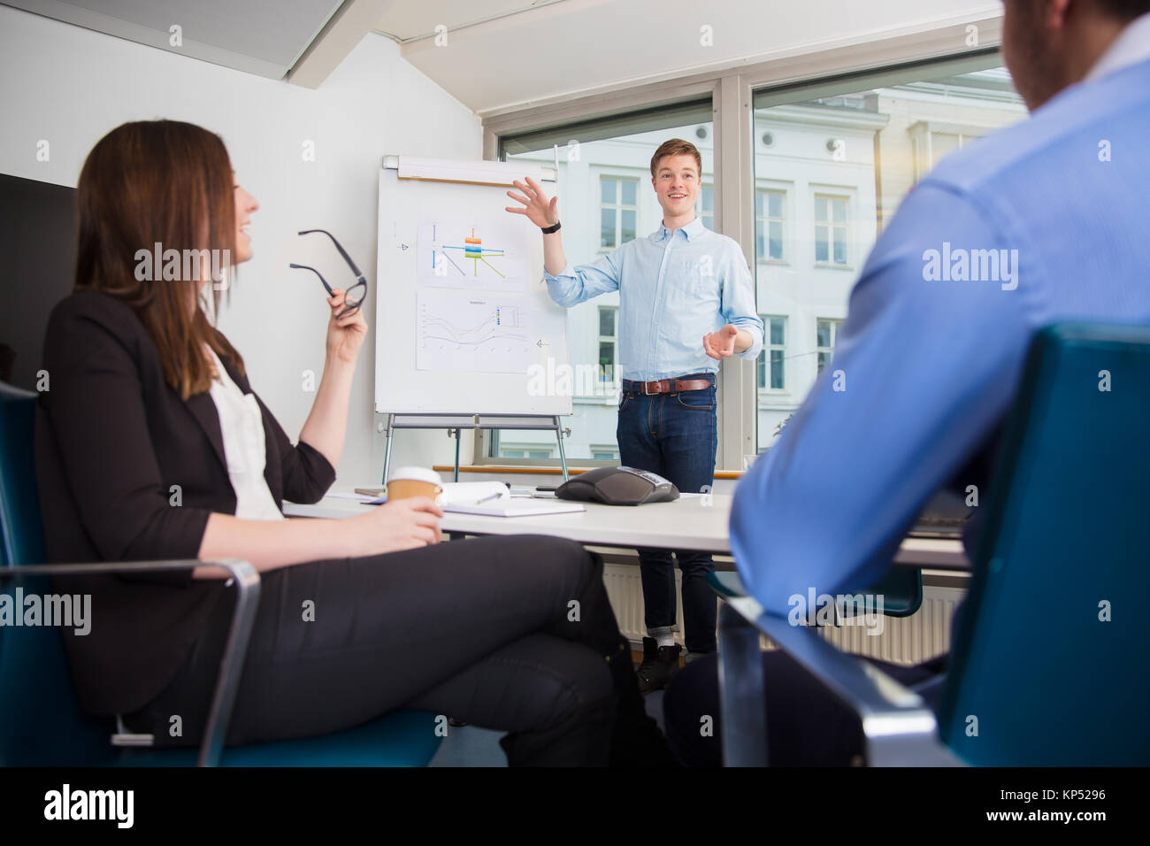 Smiling Businessman Gesturing While Giving Presentation To Colle Stock ...